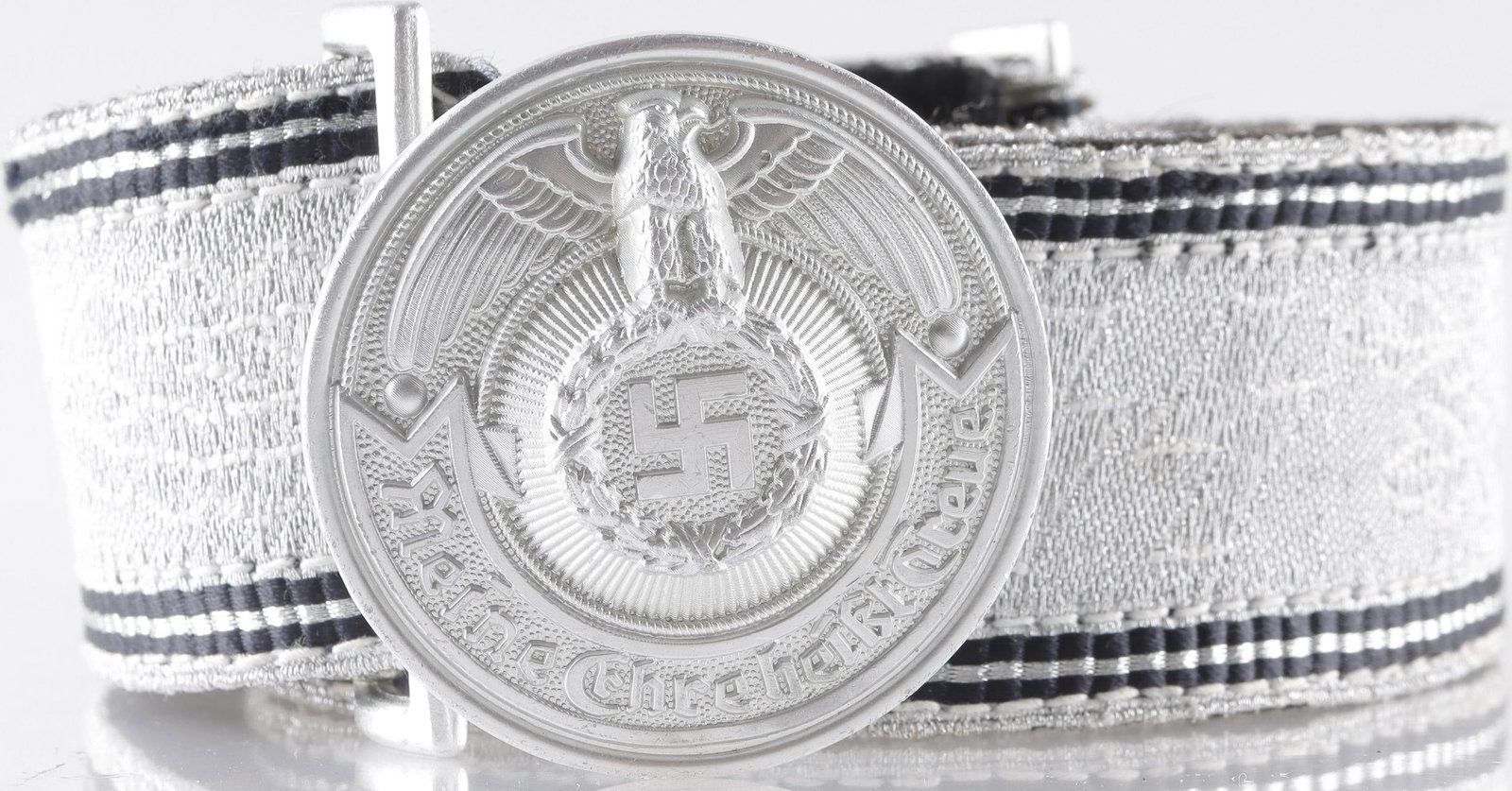 WWII Waffen SS Officer's Brocade Belt German Reich: SS Officer Brocade belt with silver-aluminum fabric construction. Buckle is constructed of aluminum alloy and displays RZM and SS stamps on reverse. Buckle measures approximately 2 inches in diameter.