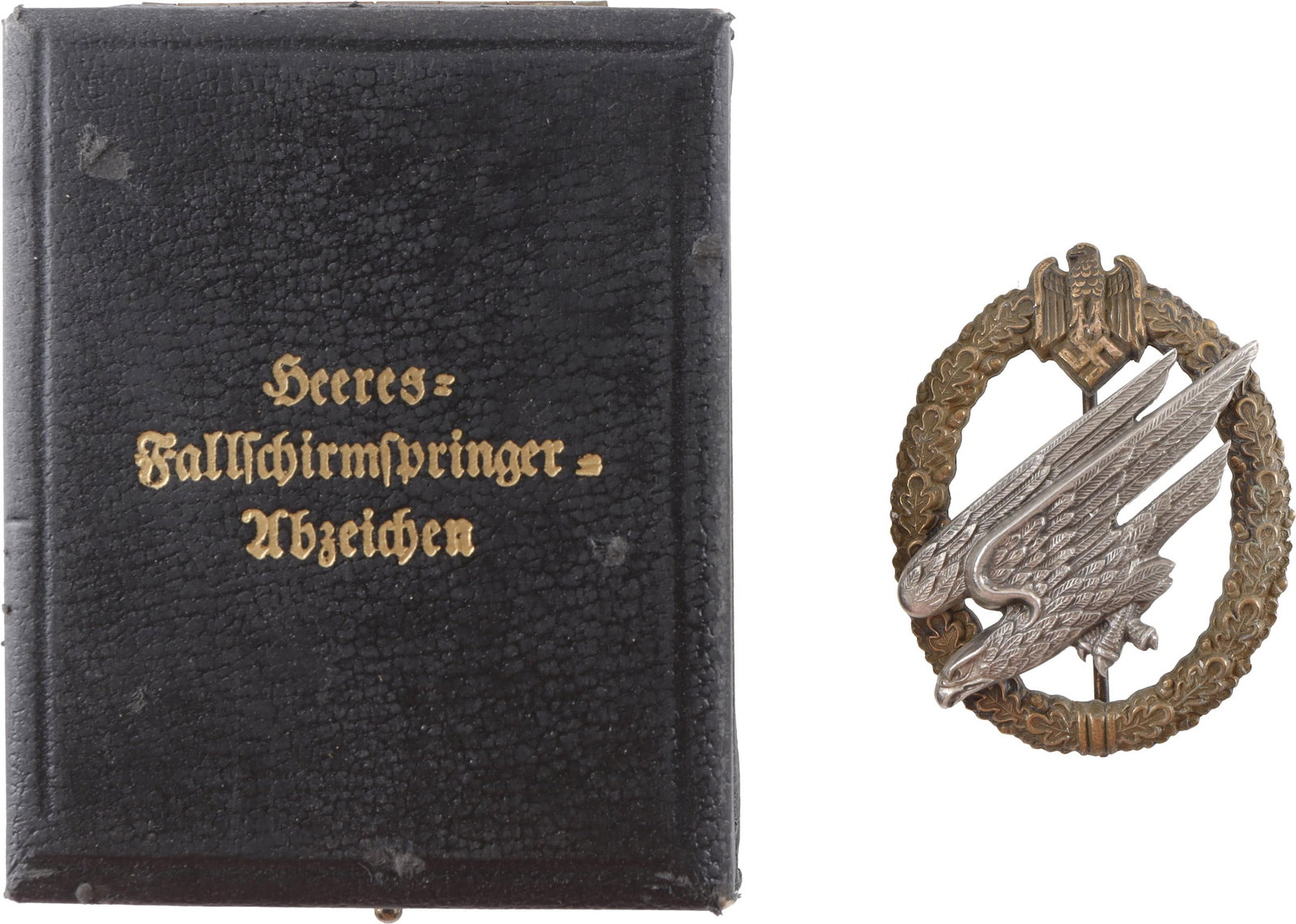 Army Paratrooper Badge WWII German Reich: Heer Fallschirmjager badge. Diving eagle Zinc construction with brass gilt. C.E. Juncker Berlin make. It measures 49.6mm. | This lot has a reserve.