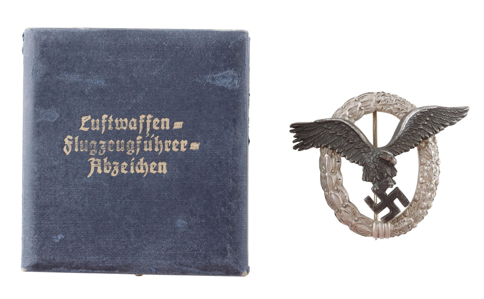 Luftwaffe Pilot Badge in Case WWII German: WWII German Reich Luftwaffe Observer badge. Oak and laurel leaf wreath with eagle clutching swastika in center. Reverse marked C.E. Juncker. It measures 51.4mm. Heavy type. Comes in case. | This lot h