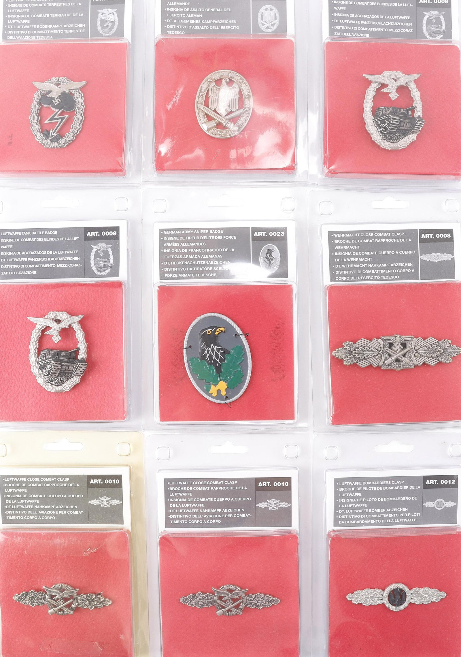 WWII German Badges Lot of 9: Includes Luftwaffe Panzer Assault, Luftwaffe Close Combat Clasp, Luftwaffe Ground Combat, general Assault badge, Army Sniper badge, Close combat clasp, Tank Assault badge.
