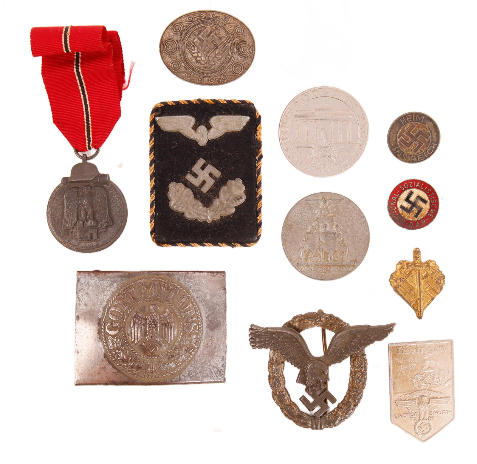 WWII German Tinnies, Collar Tab & Buckle 11 Pcs: Lot of eleven (11) pieces. Includes 7 pins and tinnies, Heer "Gott Mit Uns" steel belt buckle, Luftwaffe Pilot/Observer Badge, Eastern Front Medal and Reichsbahn official's collar tab.