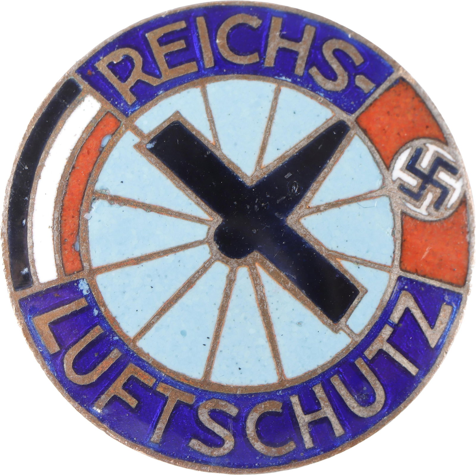 WWII German Reichsluftschutz Metal Pin Third Reich: A metal-backed enamel Reichsluftschutz pin. The center of the design features several blue rays and a plane shape in the corner, with 'REICHSLUFTSCHUTZ' around the edge. Unauthenticated.