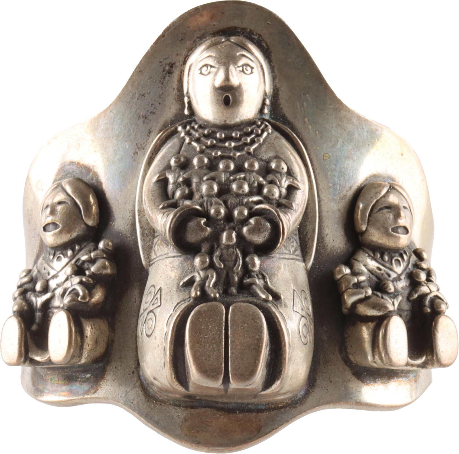 Navajo Storyteller Silver Cuff Bracelet: A silver Navajo storyteller cuff bracelet, featuring intricately detailed three-dimensional embossed figures. Stamped Sterling. Measures 2.75 inches in diameter at the widest point, with a gap of appr