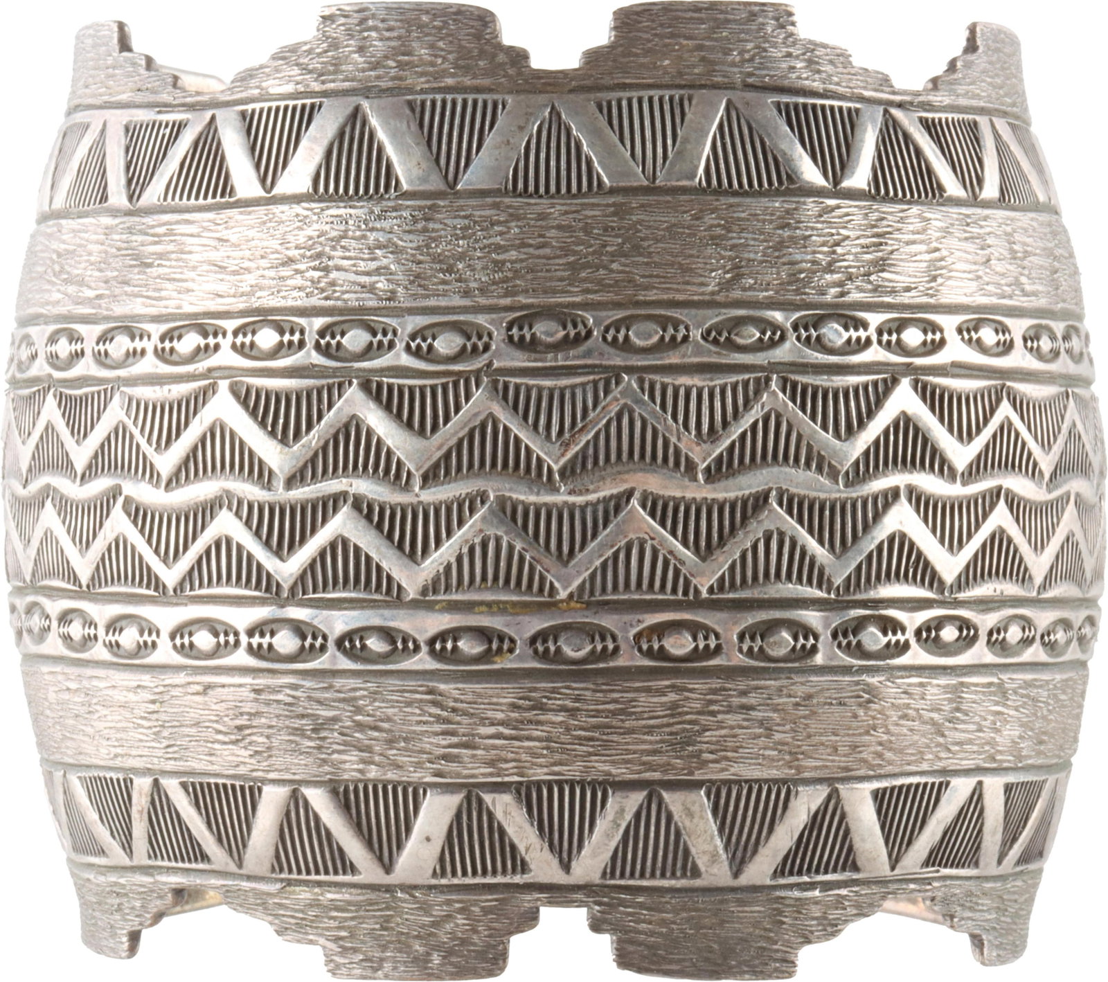 Native American Sterling Silver Cuff Bracelet: A wide silver cuff bracelet with Native American-inspired stamp-work around. Stamped Sterling on the inside, with 'T + G Segura' engraved above. Exterior circumference measures 6.75 inches with an app