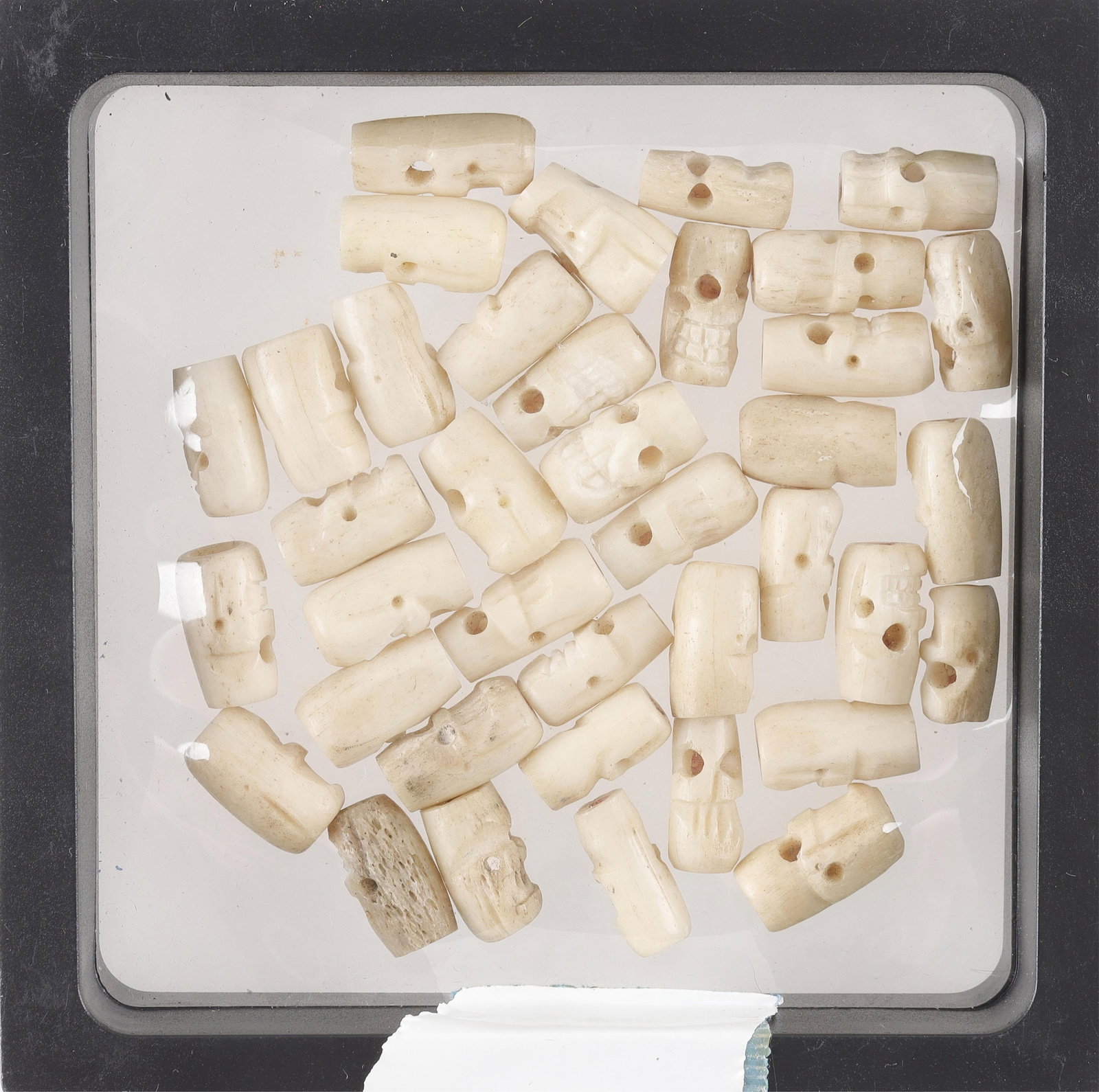 Hindu Mala Prayer Beads Antique: A small selection of antique bone beads for a mala. Carved from bone, depicting skulls.
