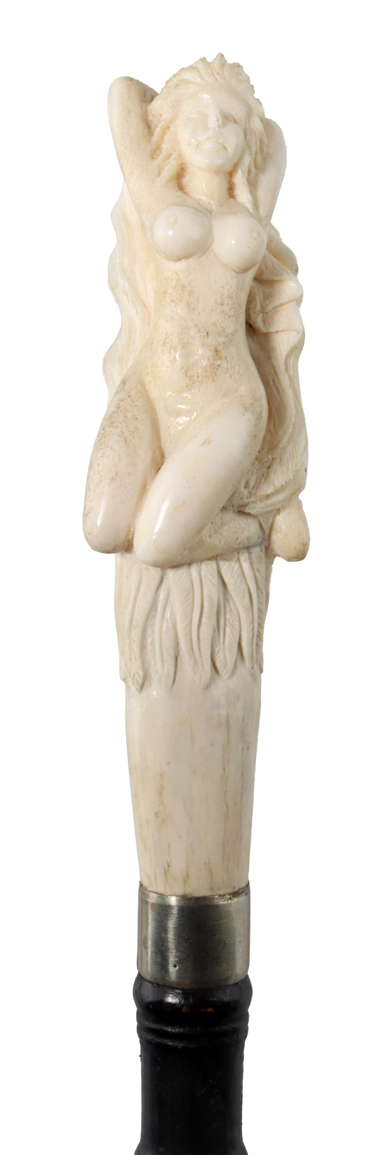 Carved Erotic Walking Stick Bone Handle: A bone handled walking stick that has been carved to depict a nude woman leaning back, with long hair and what appears to be a cape of bird feathers; possibly a swan maiden motif. Painted brass ferrul