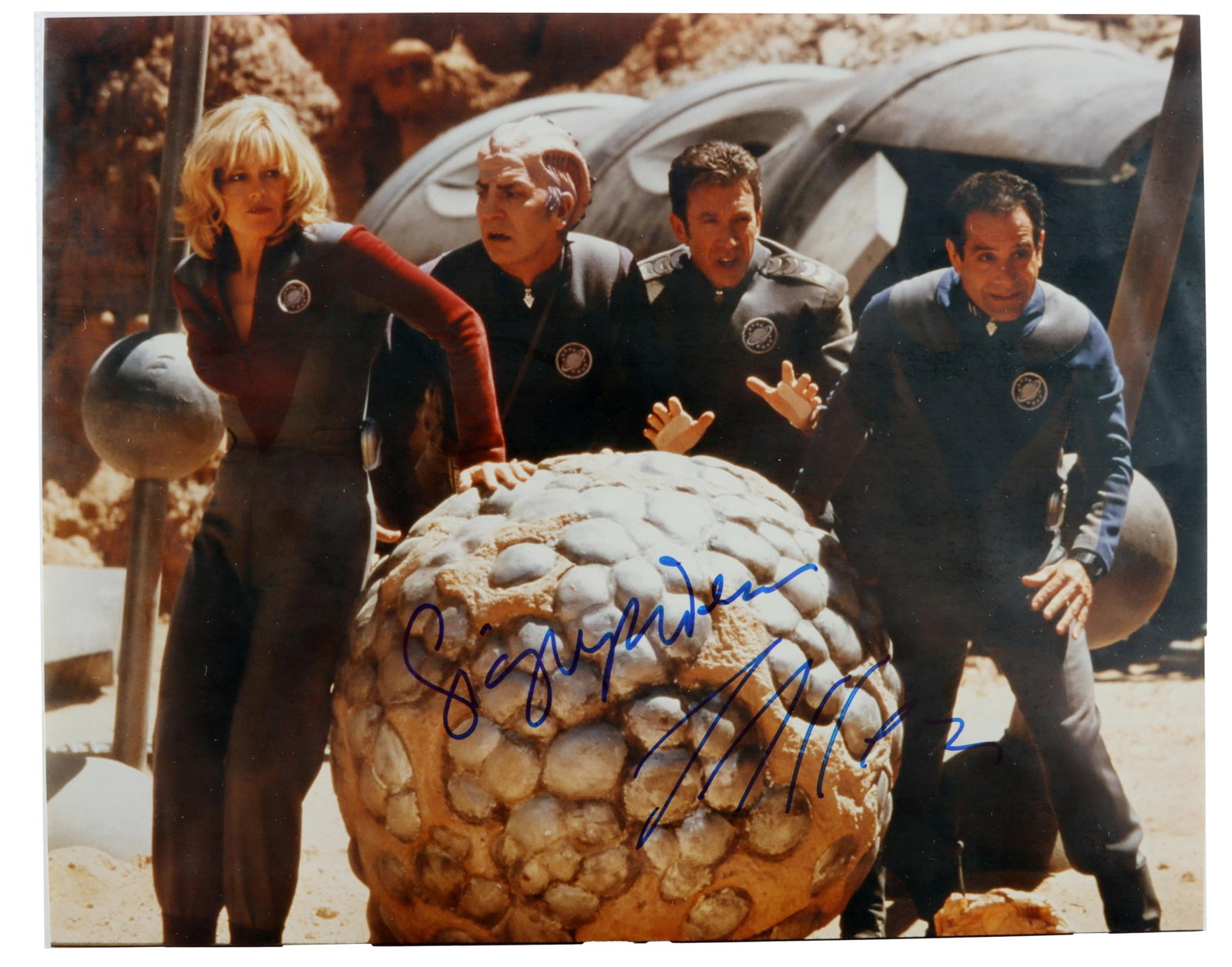 Galaxy Quest Signed Movie Photograph Collectible: A glossy full-color movie still from Galaxy Quest, signed by Sigourney Weaver and Tim Allen. Measures 8" x 10" (8 1/8" x 12 1/2" including cardboard insert and paper envelope). Unauthenticated.