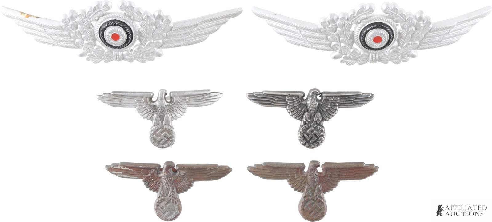 WWII Third Reich Visor Insignia Lot: WWII Third Reich Visor Insignia. Two Luftwaffe Visor Wreath and Cockade measuring 143millimeters x 43millimeters. Four Wehrmacht Reichsadler visor badges measuring 70millimeters x 31millimeters. Non