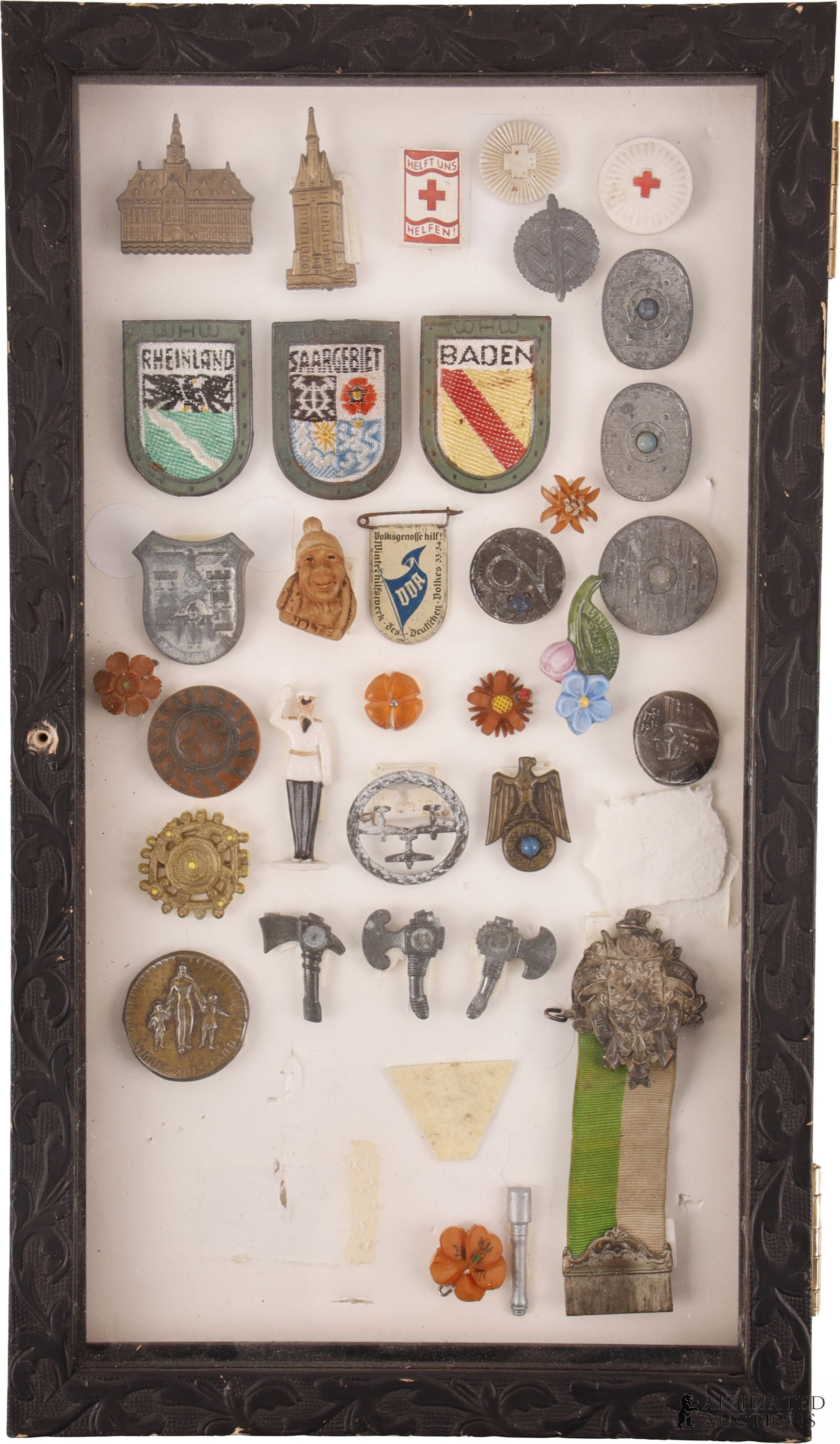 WWII German Tinnie Lot of 34: Approximately 34 tinnies from Germany including a silver shooting medal. Very good condition. Comes in 14 X 8 frame. | This lot has a reserve.