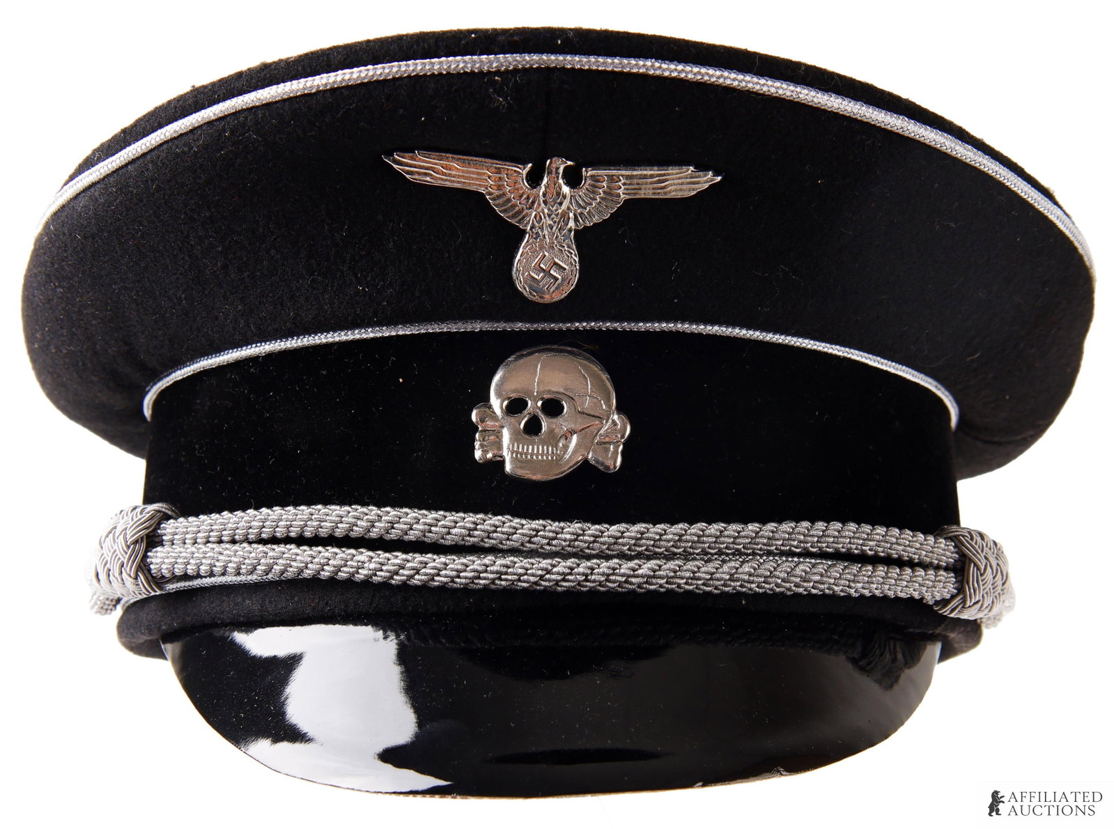 Allgemeine-SS Visor Cap WWII German Third Reich: A visor cap bearing the Totenkopf and Reichsadler badges of the Waffen-SS, on black cloth with silver bullion threading. Diamond shield on interior has the SS-Siegrunes. Size 58.