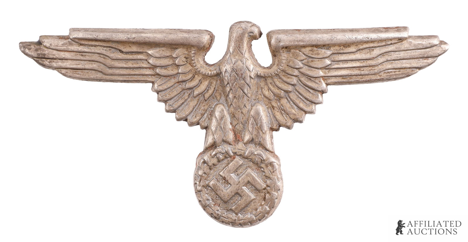 SS Reichsadler Pin German Reich WWII: German Reichsadler visor pin with "pigeon head". Possesses an RZM maker's mark on reverse. Zinc construction. Measures approximately 2 1/2 inches in wingspan. Unauthenticated. | This lot has a reserve
