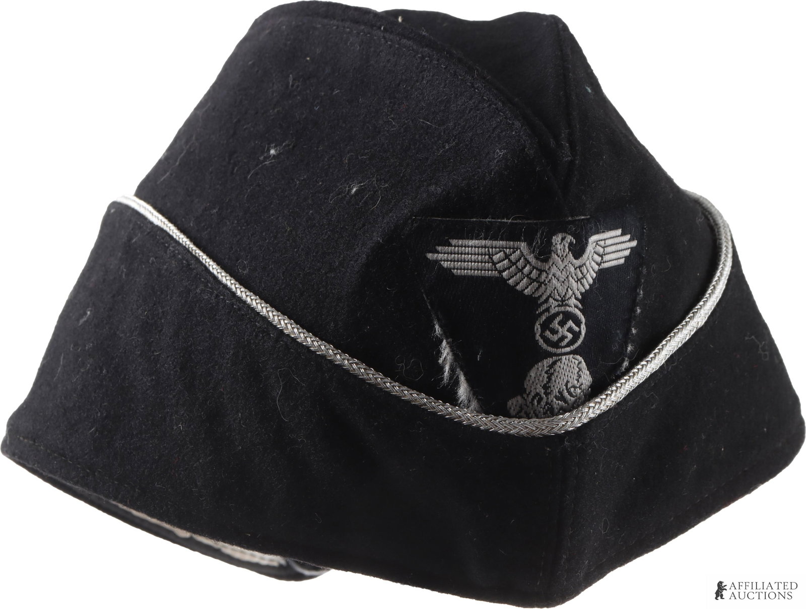Unauthenticated Allgemeine SS Overseas Cap: Garrison side cap for the Allgemeine-SS. Reichsadler and Totenkopf patch on front. Short wool construction with silver bullion piping. RZM and SS-Siegrunes tag on inside; remnants of removed tag over 