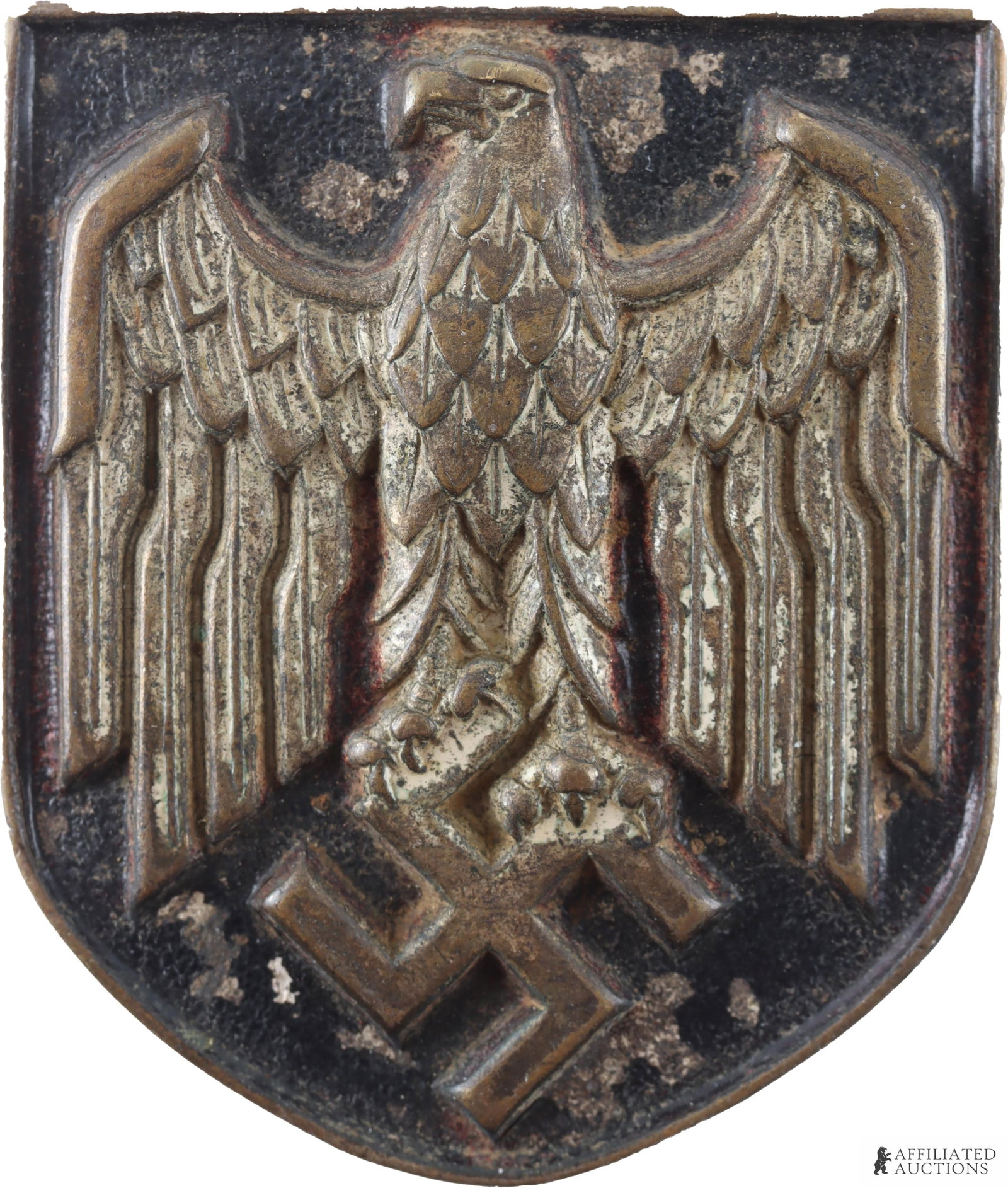 WWII Third Reich Tropical Helmet Badge: Third Reich Tropical Helmet shield Badge. This Badge is 35mm in width and 40mm in height. The badge depicts a Reichsadler. On the reverse side there are prongs to attach the badge to a helmet.