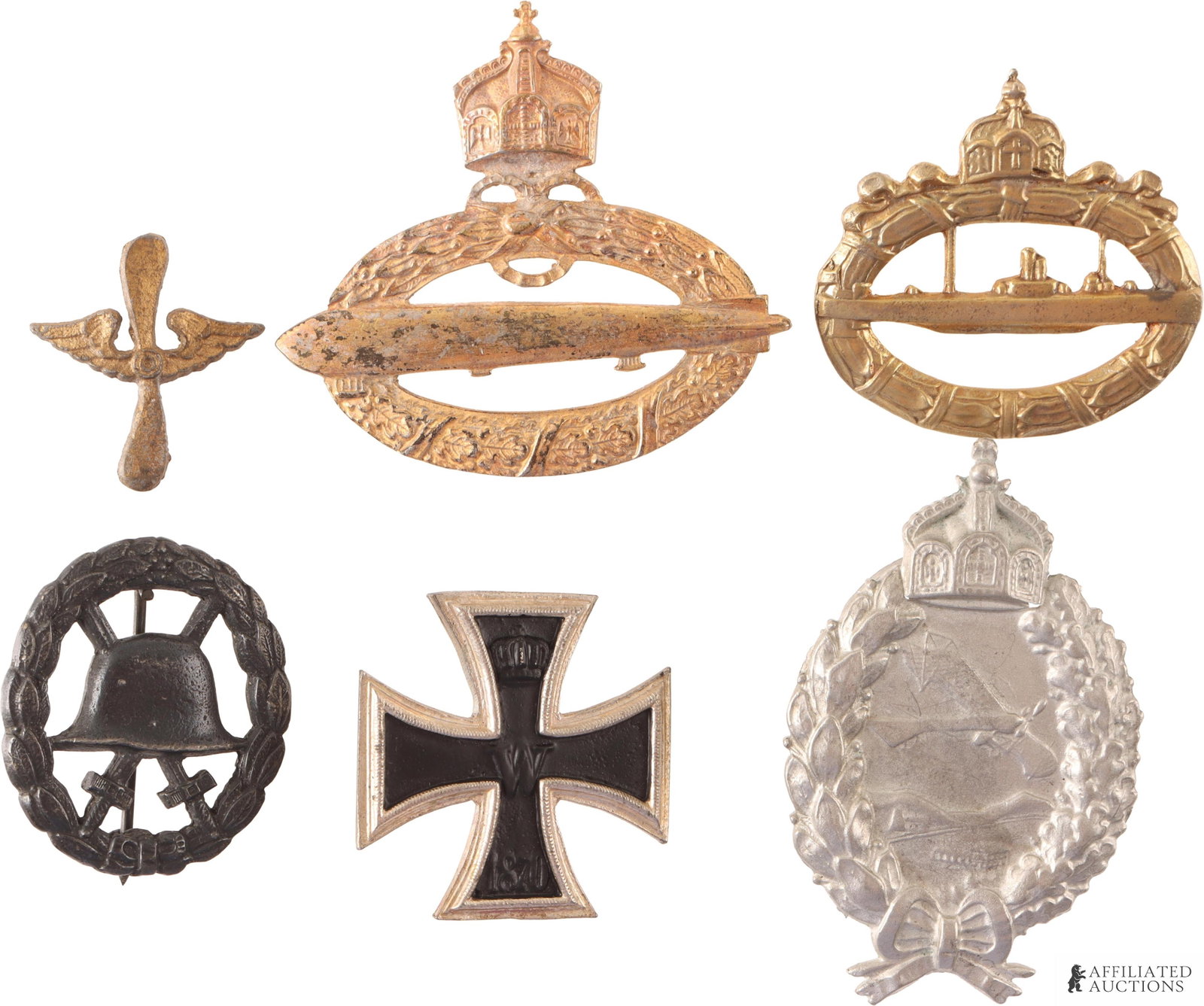 Six WWI German Badges: This lot includes an Iron Cross 1st Class, which is non-magnetic and does not feature markings on the reverse side (1.5 ? 1.5 in); an Imperial German Naval Zeppelin Badge in gold (2.5 ? 2.25 in); an I
