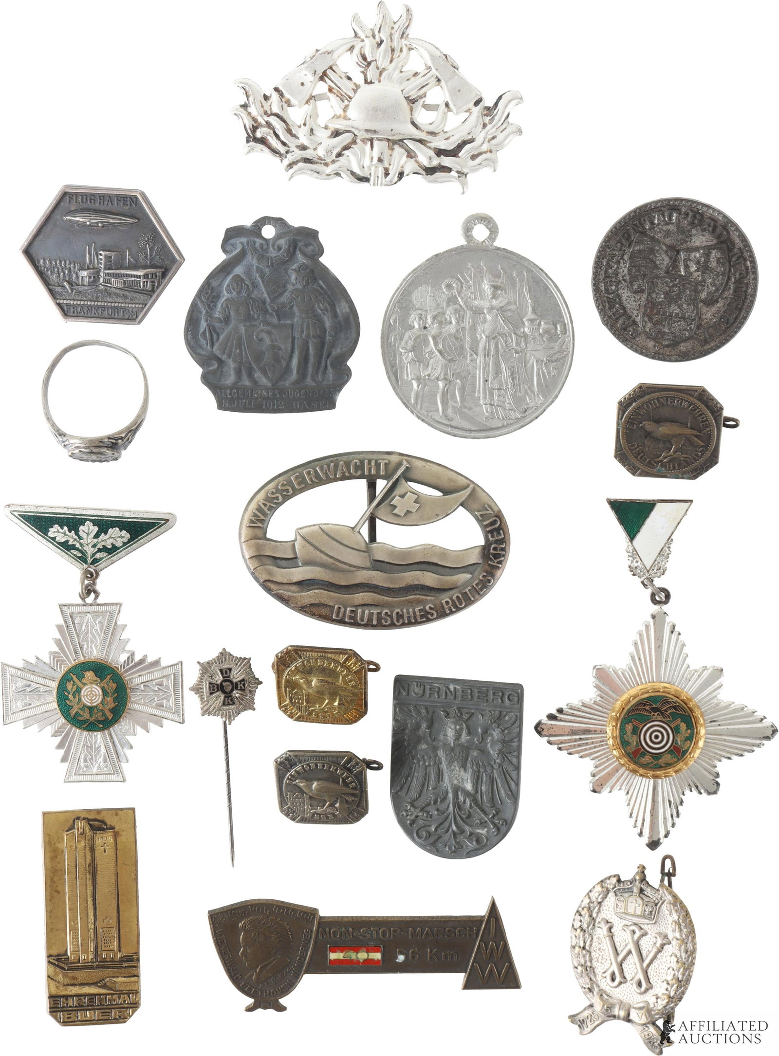 17 German/Austrian Pins, Medals, and Ring: This lot includes a post-WWII German Firefighter Cap Badge (2.5 ? 1.5 in); a tourist pin with the inscriptions ?WIENERWALD BEETHOVEN WANDERWEG NON-STOP-MARSCH 56 Km IWW? (2.75 ? 1.125 in); a BDKK Hono