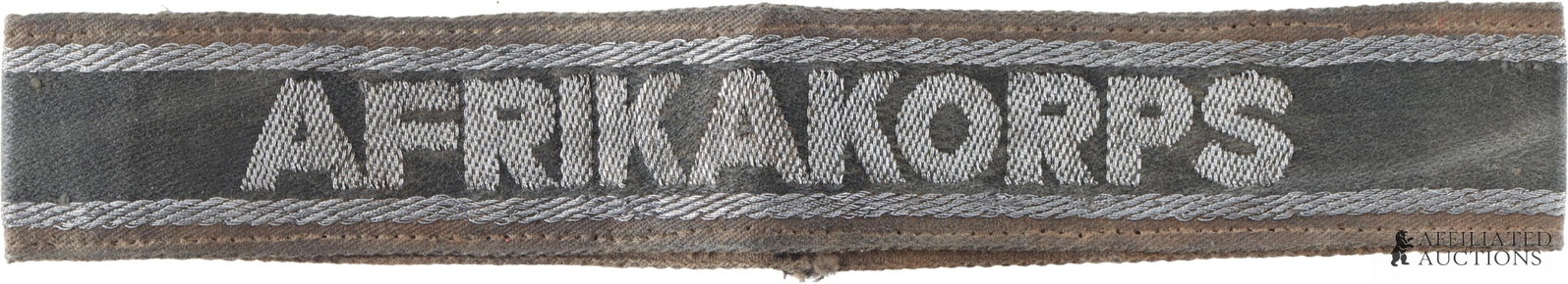 WWII German Third Reich Afrikakorps Campaign Cuff: A WWII German Afrika Korps campaign title cuff, featuring aluminum bullion 'AFRIKAKORPS' and trim on black fabric with a khaki backing. Measures approximately 7 1/2" x 1 1/8". Does not fluoresce under
