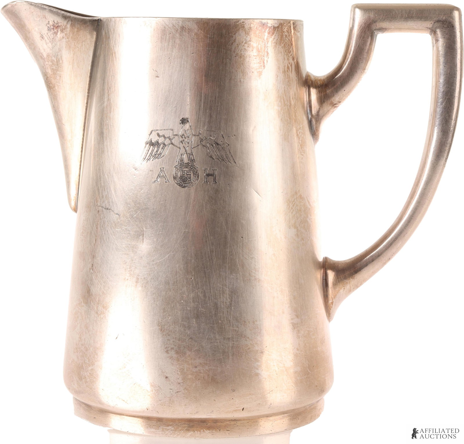 Adolf Hitler Creamer Pitcher WWII German Reich: AH monogrammed with Reichsadler. Bottom is stamped 50 cl, Wellner Soehne. It measures 5 1/8 X 6 inches. | This lot has a reserve.