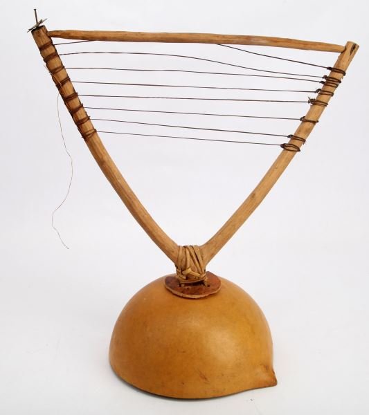 1920's SIERRA LEONE WEST AFRICA GOURD HEADDRESS: Made from a half gourd with attached "V" shaped limb and strings. In very good condition. 14 inches tall and 15 inches across. Part of disc on top is missing. From the collection of Glen Rosselot, mis