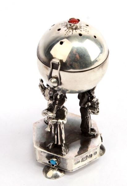 RUSSIAN SILVER JUDAIC SCENT BOX WITH MUSICIANS: Judaic scent box measures approximately 3 inches in height and is hallmarked A.A, 1894, 84. Scent box affixed atop three musicians and features both a blue and red set stone. Some tarnishing; overall 