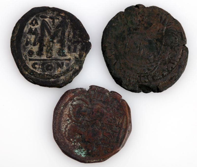 GROUP OF THREE ANCIENT BYZANTINE COINS: Group includes one Justinian Follis, and two Justin II and Sofia follis coins. Some corrosion to the Justin II and Sofia coins; overall in very good condition.