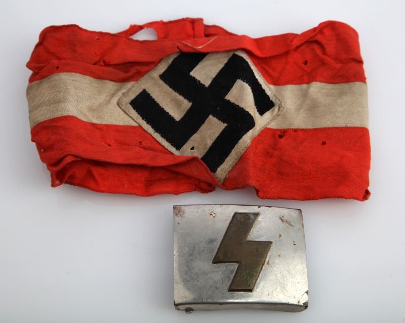 GERMAN JUGEND DJ BELT BUCKLE & HJ ARMBAND: Pre-WWII German DJ Deutsche Jugend leader's belt buckle with single brass Sig rune and die-cast nickel-plated ground with heavily worn RZM mark on reverse. Measures approximately 2.5 by 2 inches and i