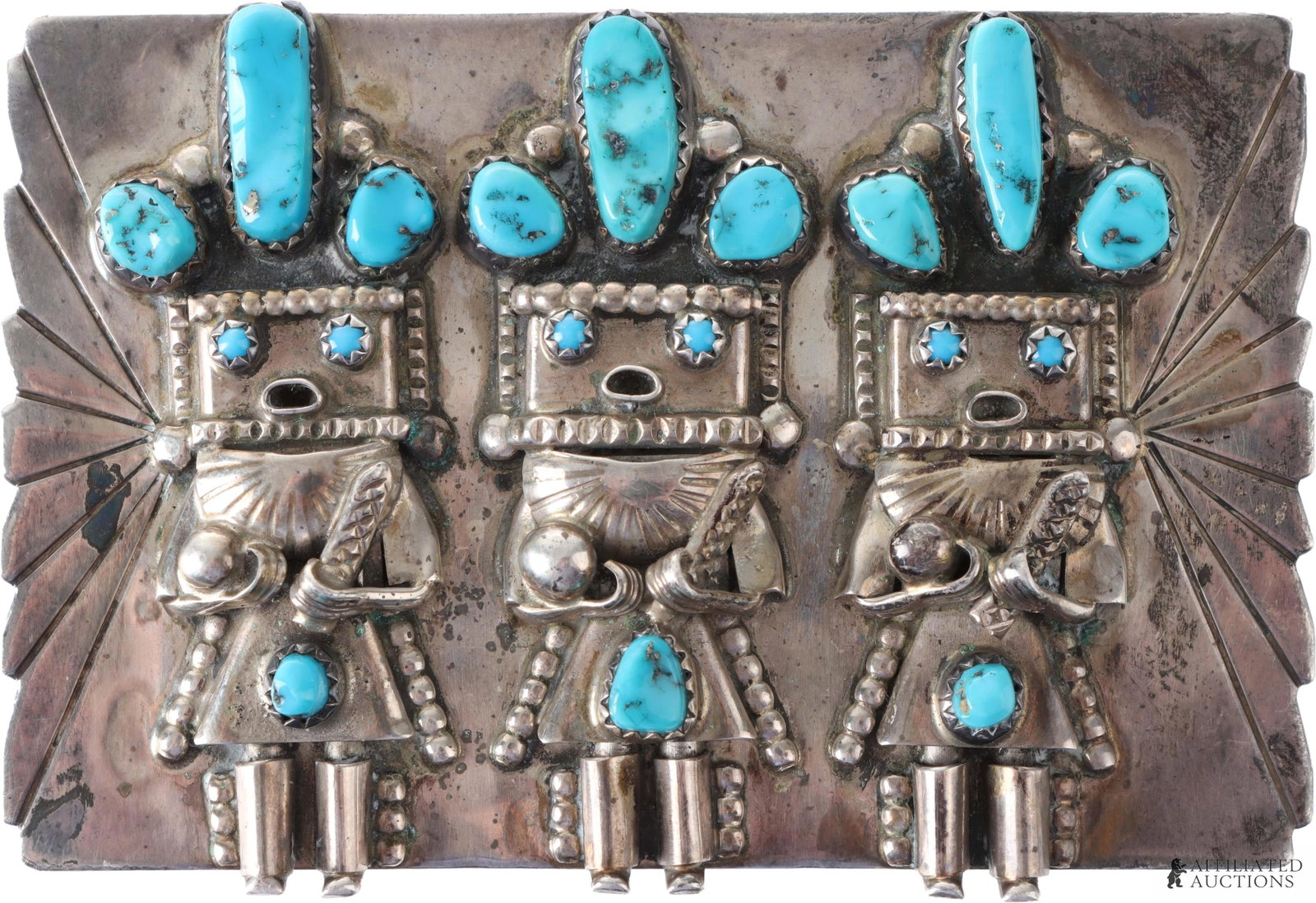 Southwest Navajo Kachina Belt Buckle .925 Silver: A .925 silver and turquoise belt buckle, with three Navajo kachina figures on the front. Turquoise appears to be Sleeping Beauty. Unsigned. Weighs 62.7 grams. 3x2 inches. | This lot has a reserve.
