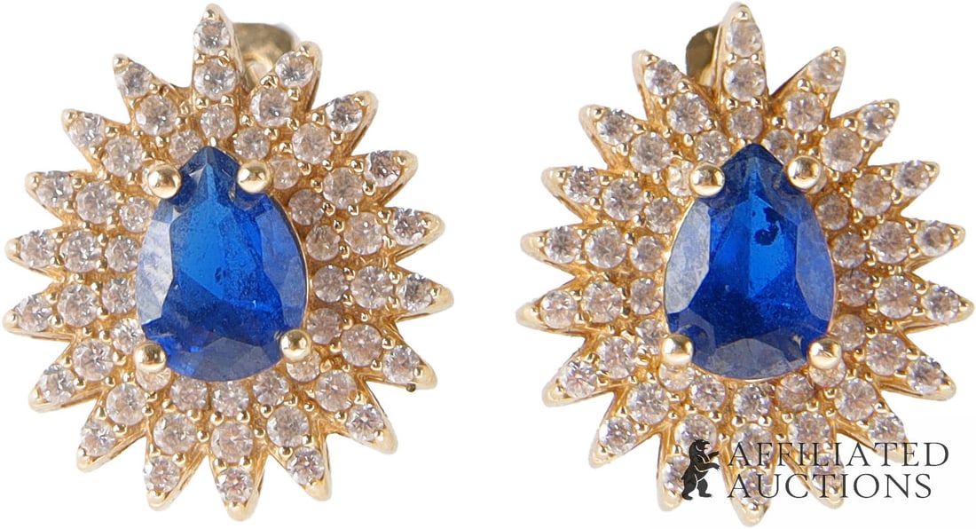 Blue Spinel Diamond Earrings by Louis J. Meyer: A pair of spinel earrings, set in 14K gold that is stamped '14K' and the Louis J. Meyer Inc. mark of an 'M' in a circle; spinel is an August birthstone. Each feature a pear-cut, prong-set blue spinel 