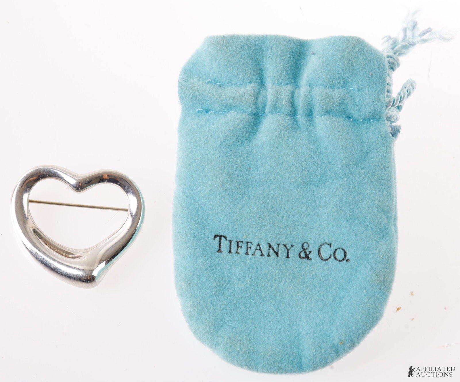 Tiffany & Co Open Heart Collection Silver Brooch: The simple, evocative shape of Elsa Peretti Open Heart designs are an expression of love's limitless bounds. Marked "Tiffany & Co Elsa Peretti 925 Spain. It measures 34.75 X 34.66mm.