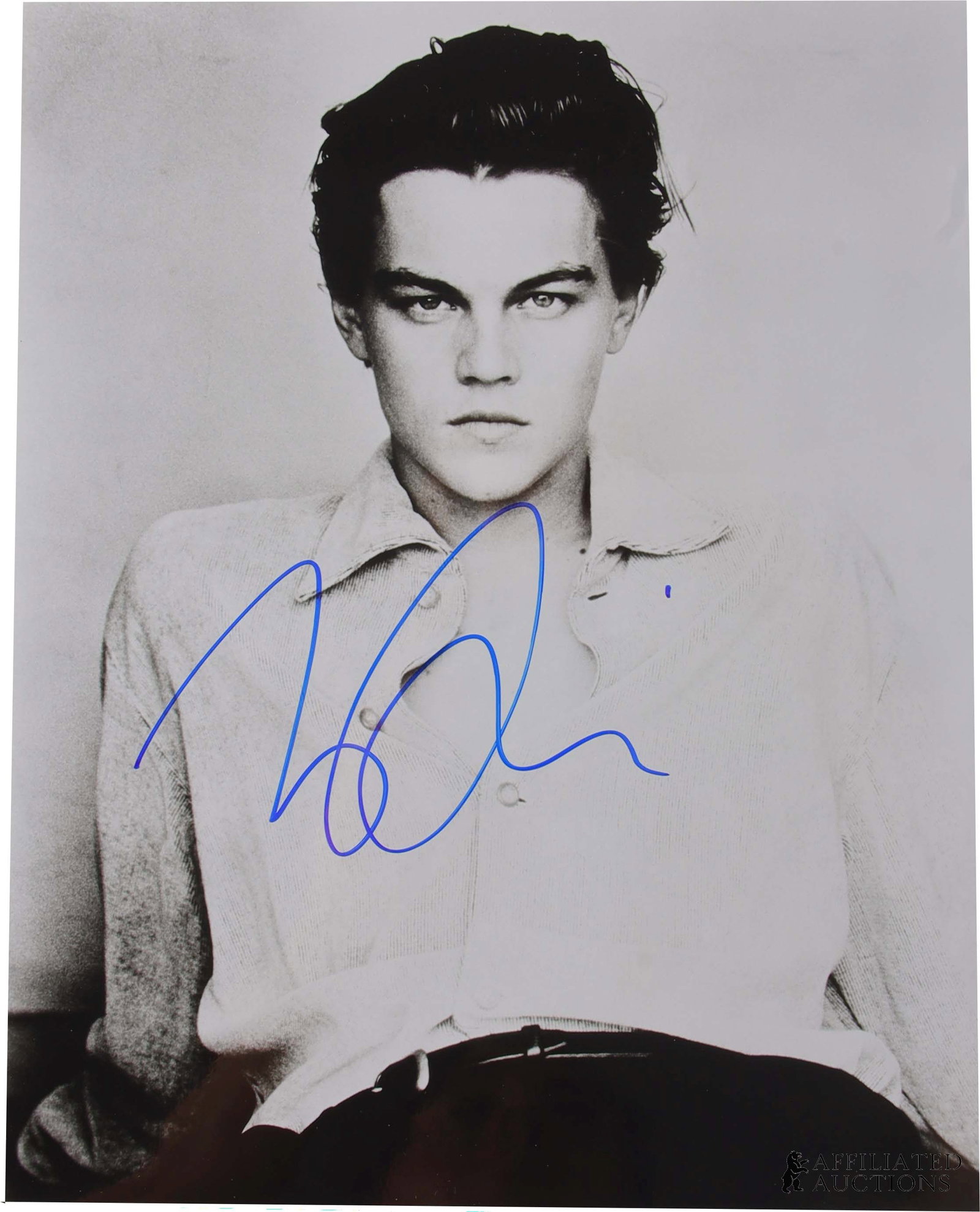 Leonardo DiCaprio Autographed Photograph: An autographed seated portrait photograph of Academy Award-winning actor Leonardo DiCaprio. Signature acquired in person through direct collection by autograph dealer James Reeves and his team of agen