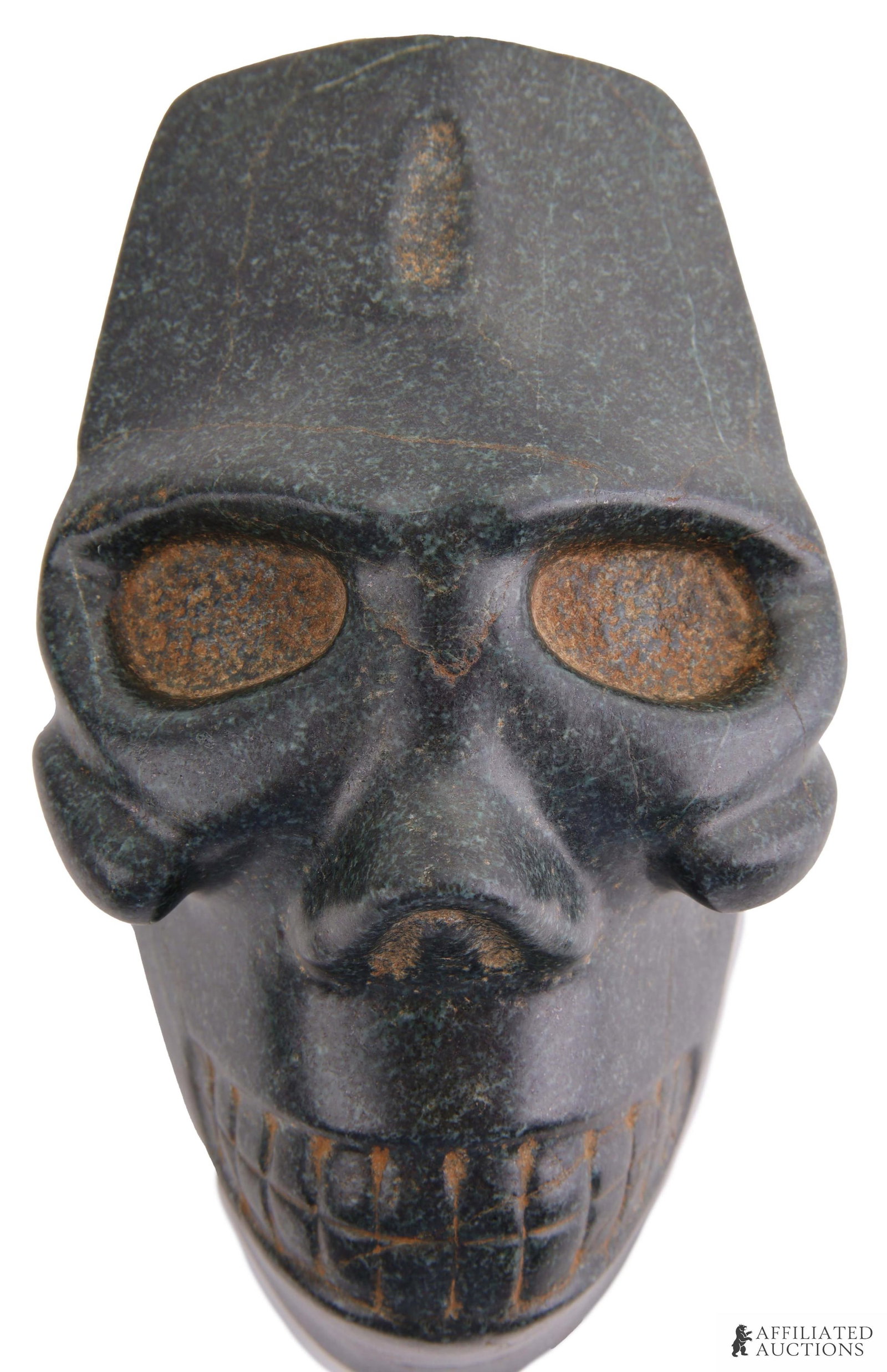 Taino Magnetite Skull Effigy Caribbean: An outstanding stylized skull effigy, with dynamic dental display, sunken deep set eyes, well defined embossed cheek bones, and uniquely formed tabular oblique skull modification. An incredible exampl