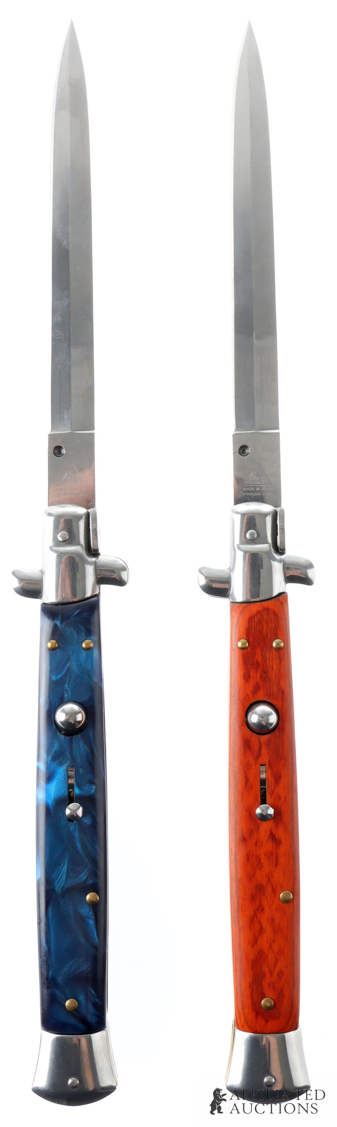 2 AKC 13 Inch Italian Switchblade Knife Lot: Lot of two AKC Italian-made switchblades. Knives measure 13 inches open, 7 inches closed. Blades are of stainless steel construction. One grip is of stained wood construction, one of blue opalescent p