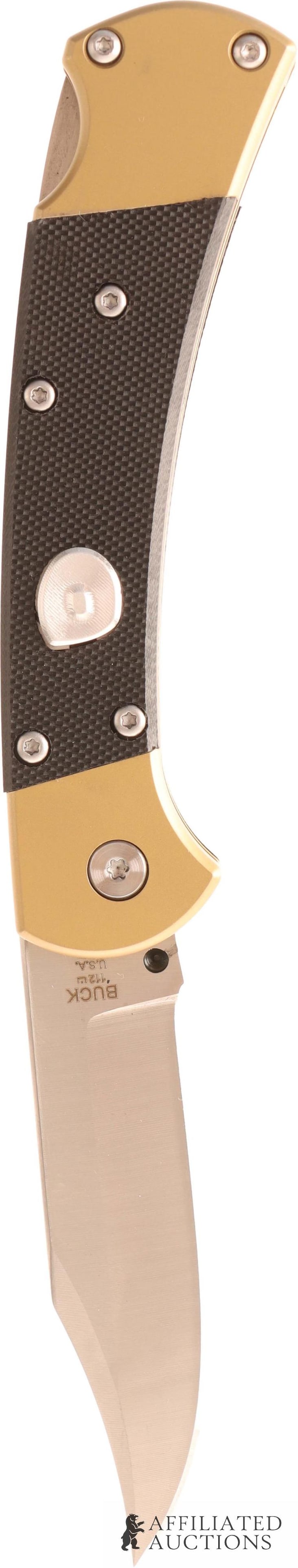 Buck 112 Ranger Switchblade Knife: Genuine ebony with brass bolsters. Steel blade Measures 7 1/8 inches. Comes with leather case. | This lot has a reserve.