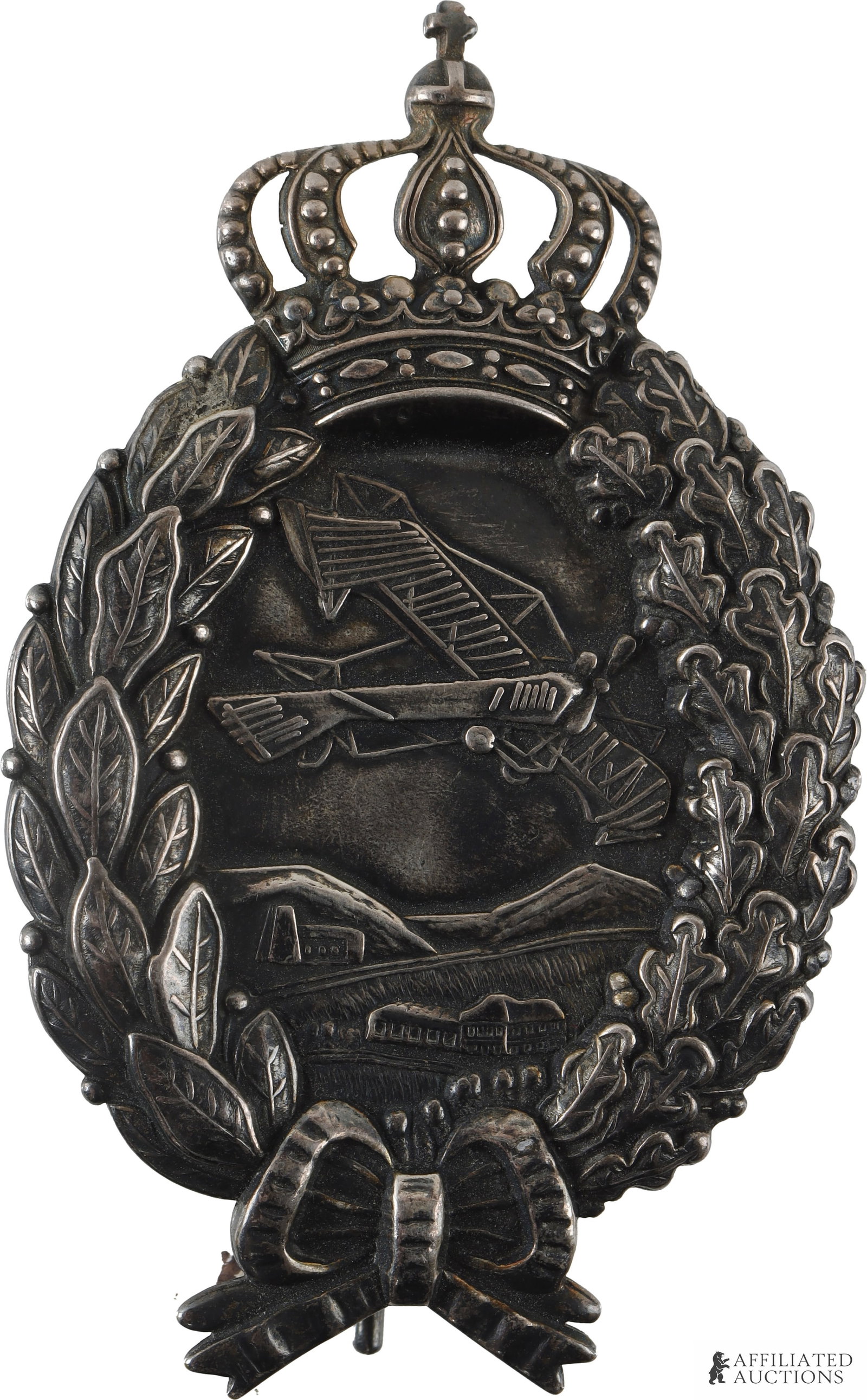 WWI German Bavarian Pilot Badge High Detail: Silver finish over magnetic badge. Fine detail with Bavarian crown on top, oak and laurel leaf, and bow. Weighs 17 grams. Measures 72mm X 44mm.