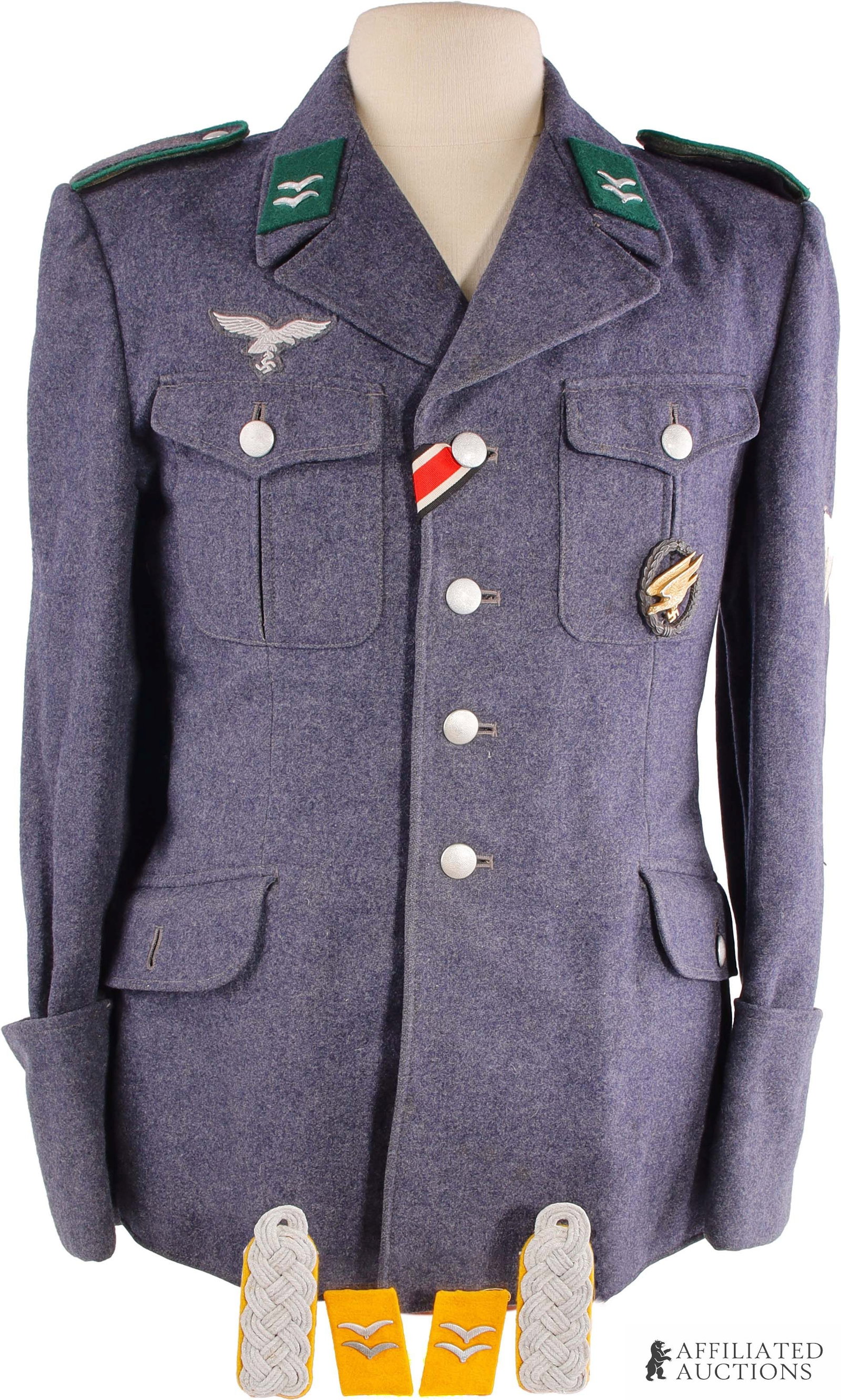 Luftwaffe Fallschirmjager NCO Service Tunic: Luftwaffe service tunic of blue wool. Grey twill liner depot marks in ink. Matching blue wool shoulder boards with green piping, green collar tabs. EK2 ribbon in second button hole, G.H. Osang-marked 