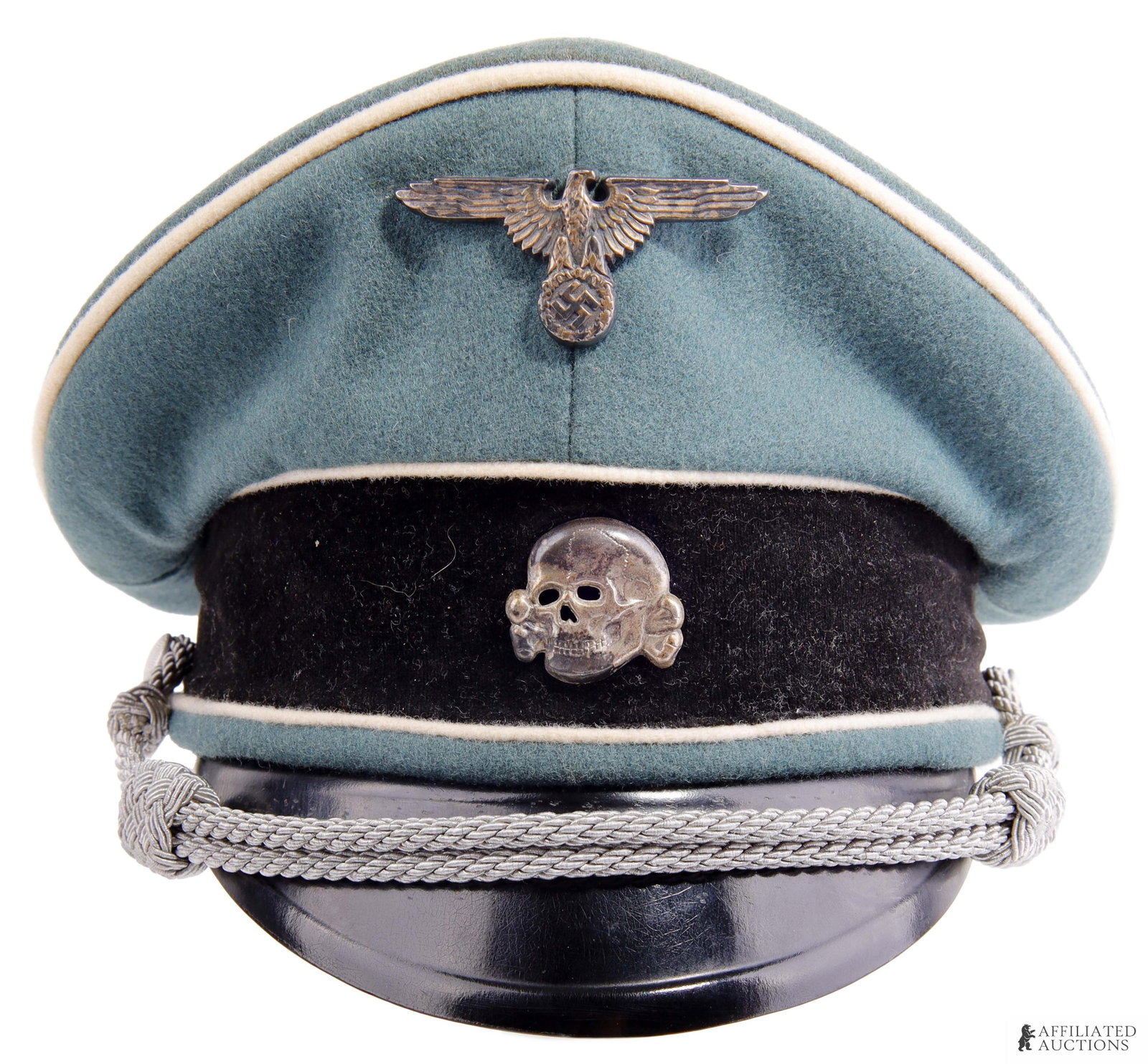 Waffen SS Officer Visor WWII German: Doe skin wool with black velvet band and white piping. Totenkopf and reichsadler are nickel silver. Reichsadler is not marked. Totenkopf is marked M1/52. Silver bullion chin strap and pebbled buttons.