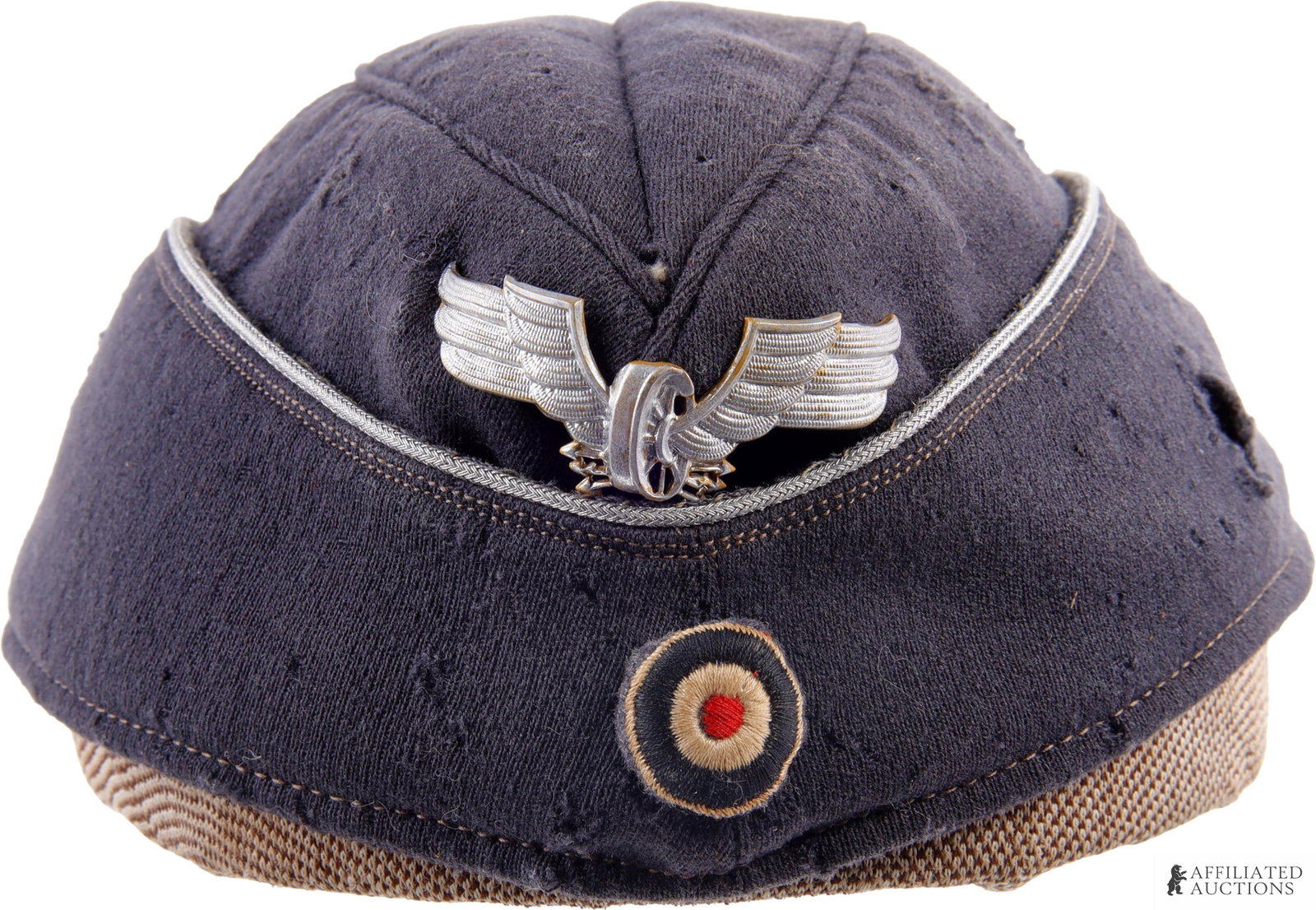 Railway Protection Police Officer Side Cap: Third Reich Bahnschutzpolizei (Railway Protection Police) officer's side cap of dark blue wool with grey rayon liner and silver piping. Front has metal winged wheel insignia over cockade. Measures 8 i