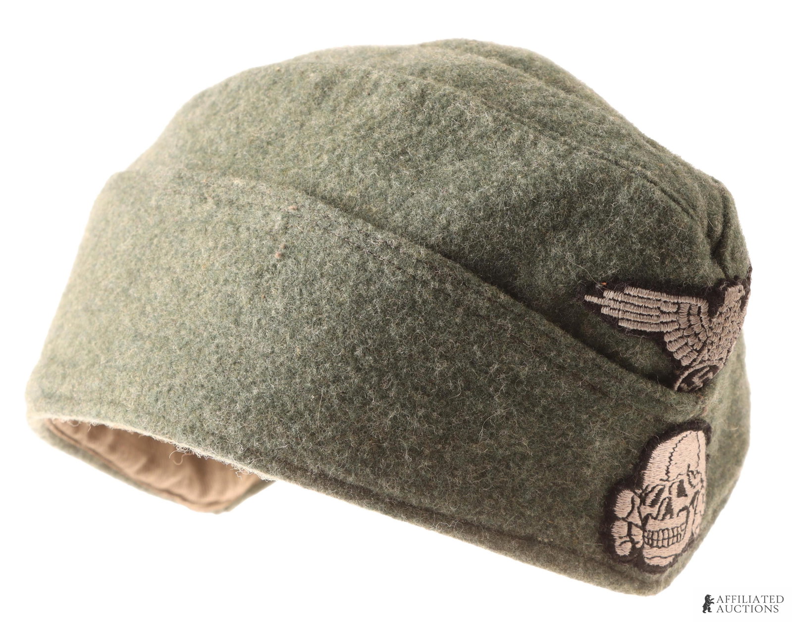 Waffen SS Overseas Cap WWII German Reich: Wool construction. The front features totenkopf and reichsadler patches. Liner on the interior stamped with 'SS' with another non-discernable stamp. Overall length is 11 inches. Unauthenticated.