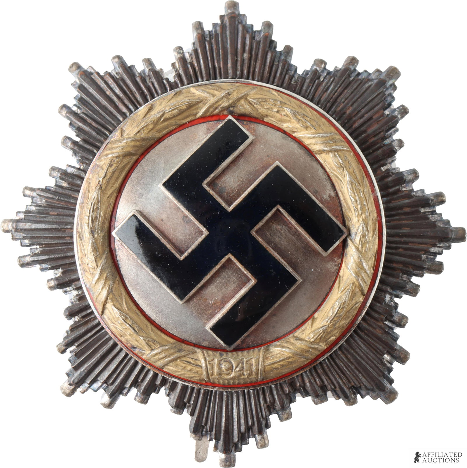 WWII German Cross In Gold Zimmerman Make: WWII Third Reich German Cross in Gold. Multipiece construction with enameled swastika on starburst pattern. Four rivet type. Stamped 20 under pin. It measures 62.81mm | This lot has a reserve.