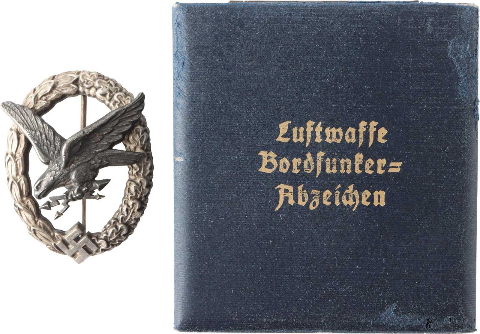 Luftwaffe Radio Operator Badge WWII German: WWII German Luftwaffe Radio Operator Badge. Eagle clutching lightning bolts on oak and laurel leaf wreath. It measures 52.71mm. Marked C.E. Juncker. Comes in case. | This lot has a reserve.