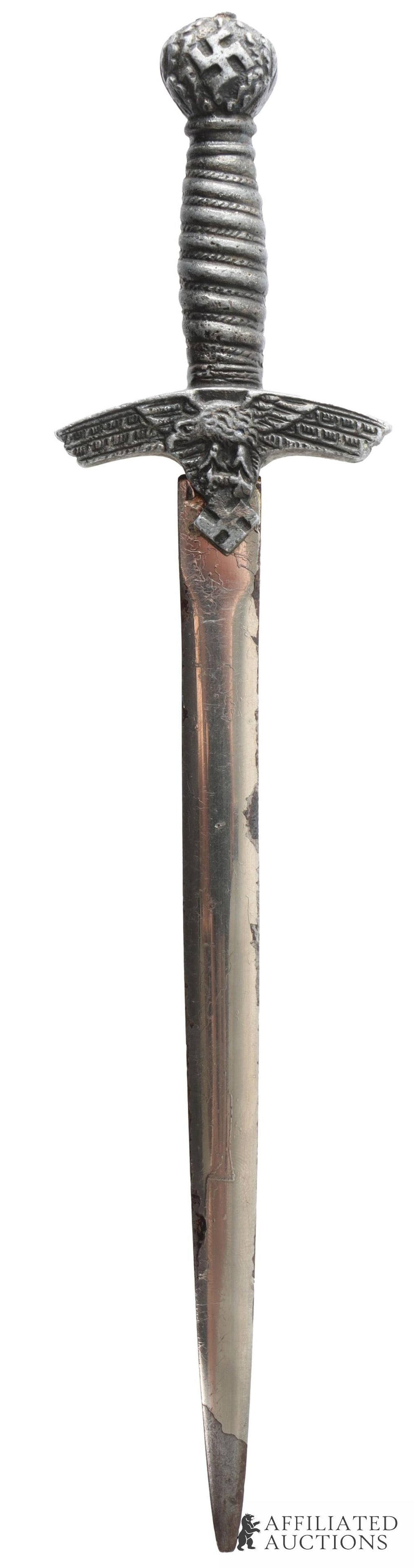 Luftwaffe Model 1 Miniature Dagger Letter Opener: WWII German Third Reich Luftwaffe Model 1 miniature dagger. Nickel plated blade. Non-magnetic handle. It measures 7 5/8 inches Very good condition. | This lot has a reserve.