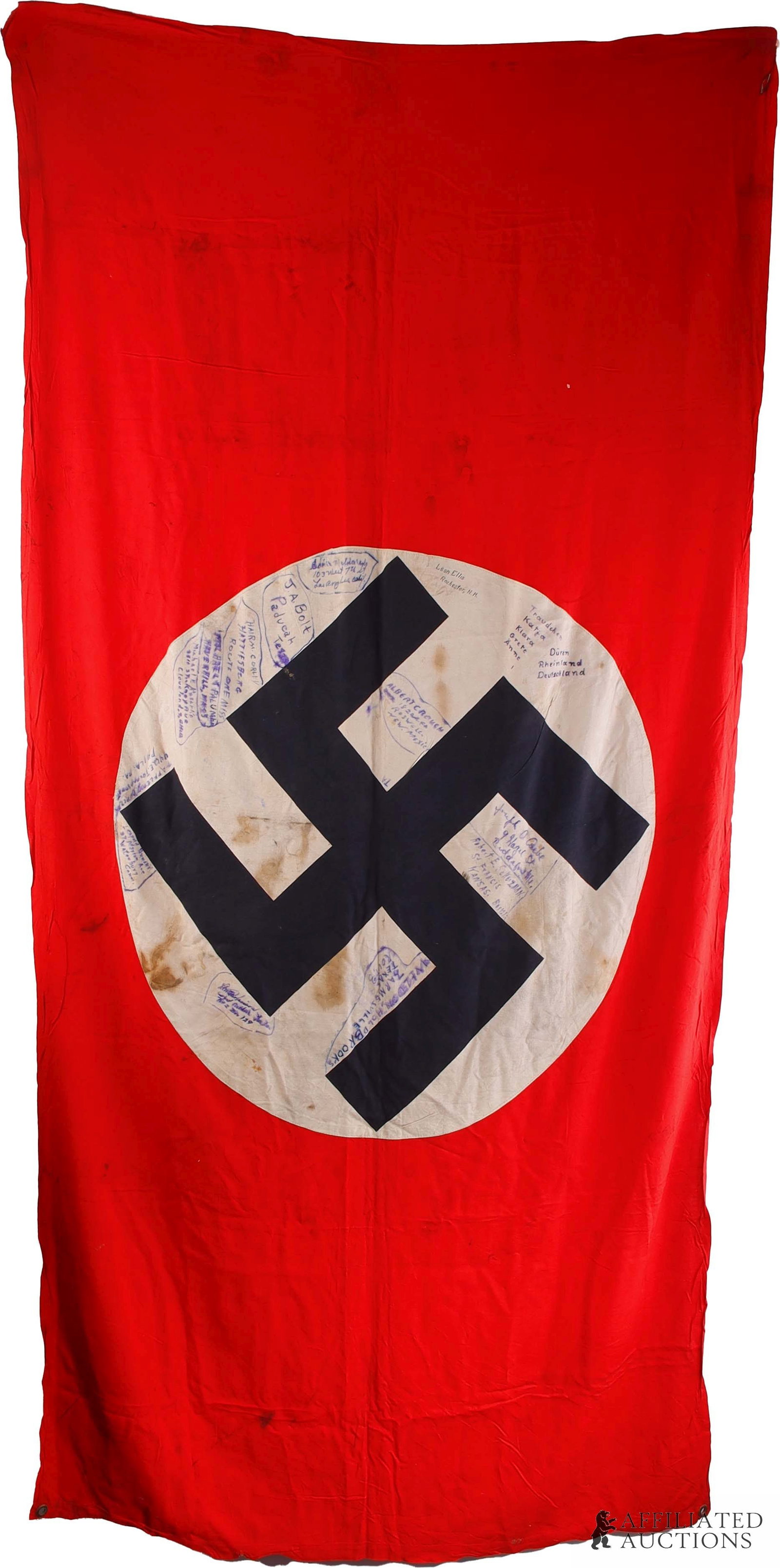 German Vehicle Identification Flag Signed Trophy: WWII German vehicle identification flag with signatures of the American GIs who captured it. Multi-piece construction, large red cotton flag with black swastika on circular white field. Metal