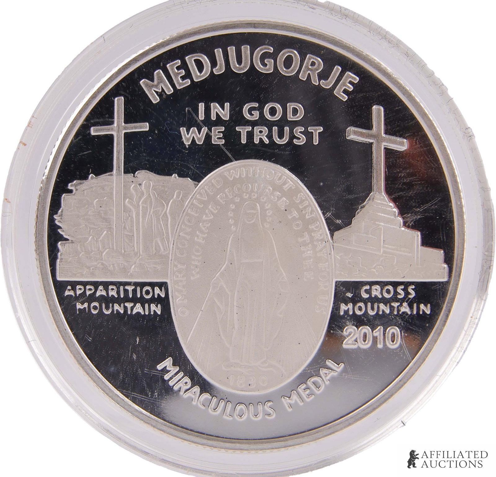 .999 Silver 1 OZT Medjugorje Miraculous Medal: A Medjugorje 'Miraculous Medal' made from one troy ounce .999 fine silver. This medal, produced by the Caritas of Birmingham, has the imagery of a secondary apparition site claimed to have been in the