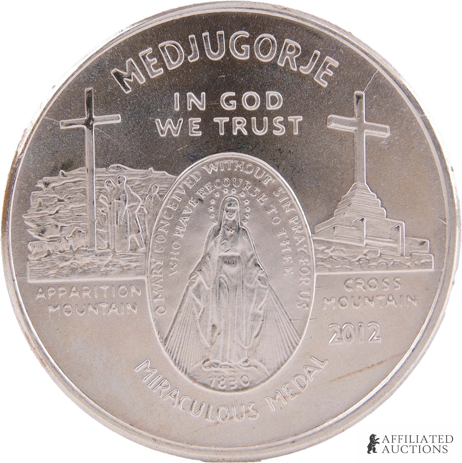 .999 Silver 1 OZT Medjugorje Miraculous Medal: A Medjugorje 'Miraculous Medal' made from one troy ounce .999 fine silver. This medal, produced by the Caritas of Birmingham, has the imagery of a secondary apparition site claimed to have been in the