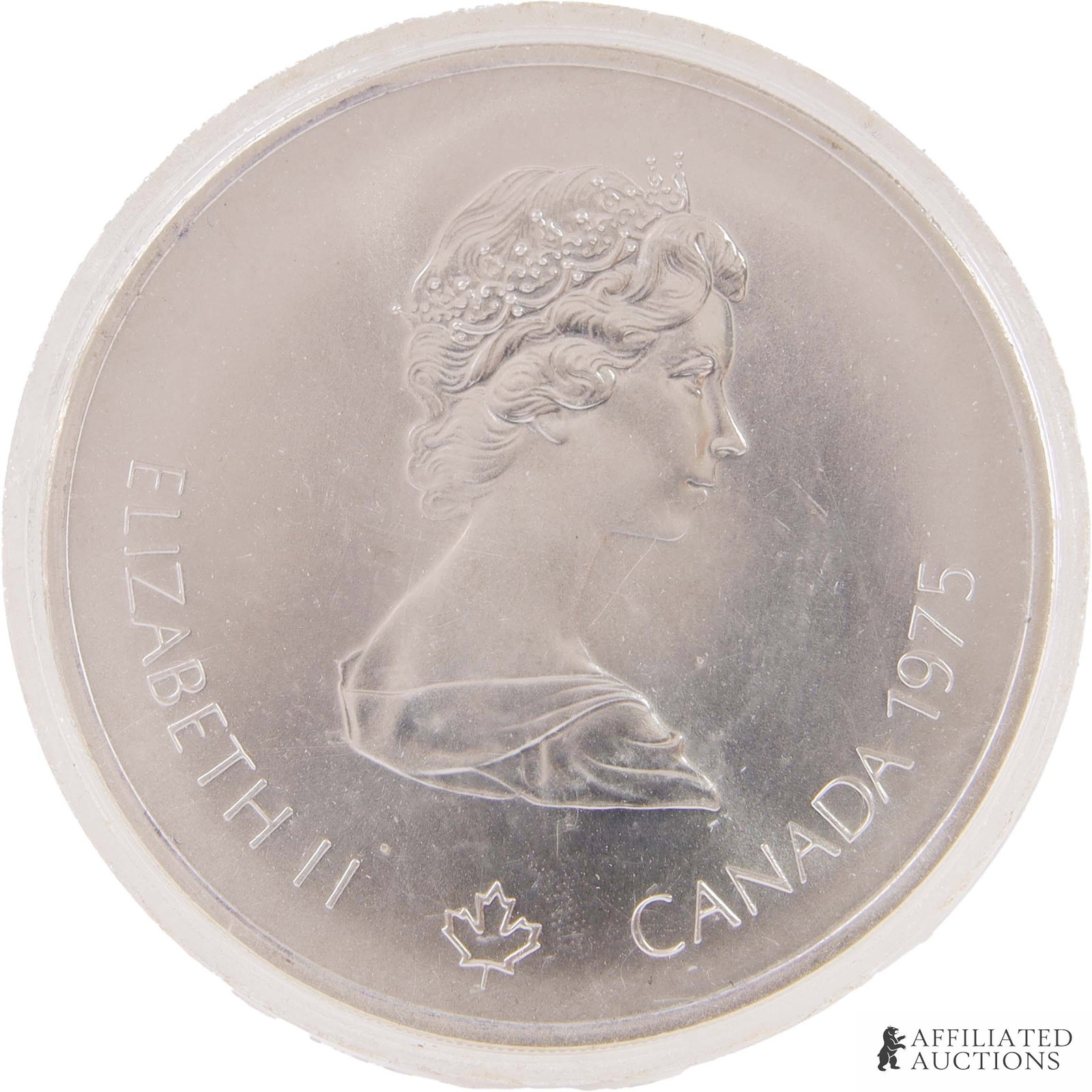 1975 Montreal Olympiad .925 Silver Coin Rowing: A .925 1975 Canadian $10 silver coin commemorating the 1976 Olympian. Obverse of coin bears a portrait of Queen Elizabeth II, reverse shows outlines of men rowing. Contains 1.4453 troy ounces of pure 
