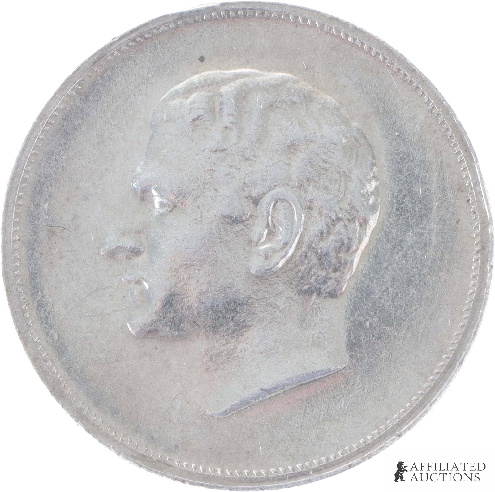 1965 Iranian 90% Silver Medal: 1965 Iran Silver Mint Medal. Weight 21.9 grams. Obverse shows a left-facing profile bust of Shah Mohammad Reza Pahlavi. Reverse shows a Pahlavi Crown with Oak and Olive leaves underneath with text in 
