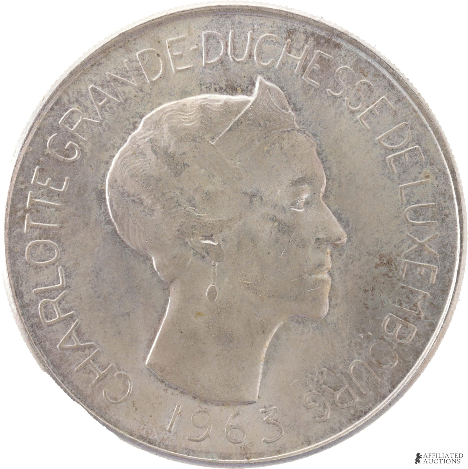 1963 100 Francs Silver Mint Coin: 1963 100 Francs Silver Coin. Weight 18 Grams. Obverse shows the Grand Duchess of Luxembourg. Reverse shows the Crowned and quartered Nassau-Luxembourg shield, supported by two crowned lions. Metal: