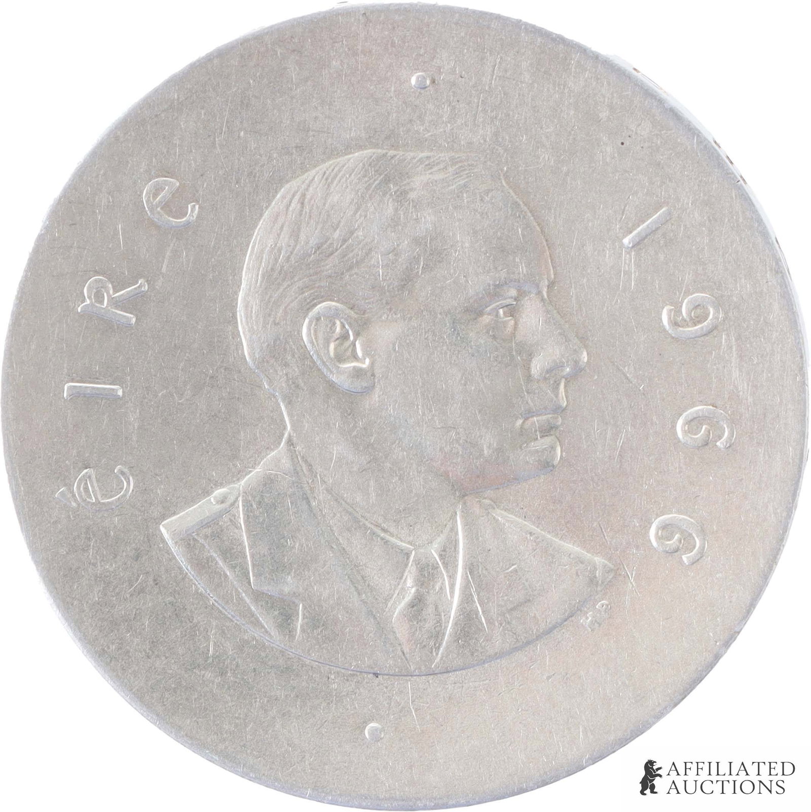 1966 Irish 10 Schilling Silver Mint Coin: 1966 Irish 10 Schilling Silver Coin. Weight 18 grams. Obverse shows the 50th Anniversary of the 1916 Easter Rising, slightly concave. Reverse shows a bust of Padraig Pearse facing right, slightly