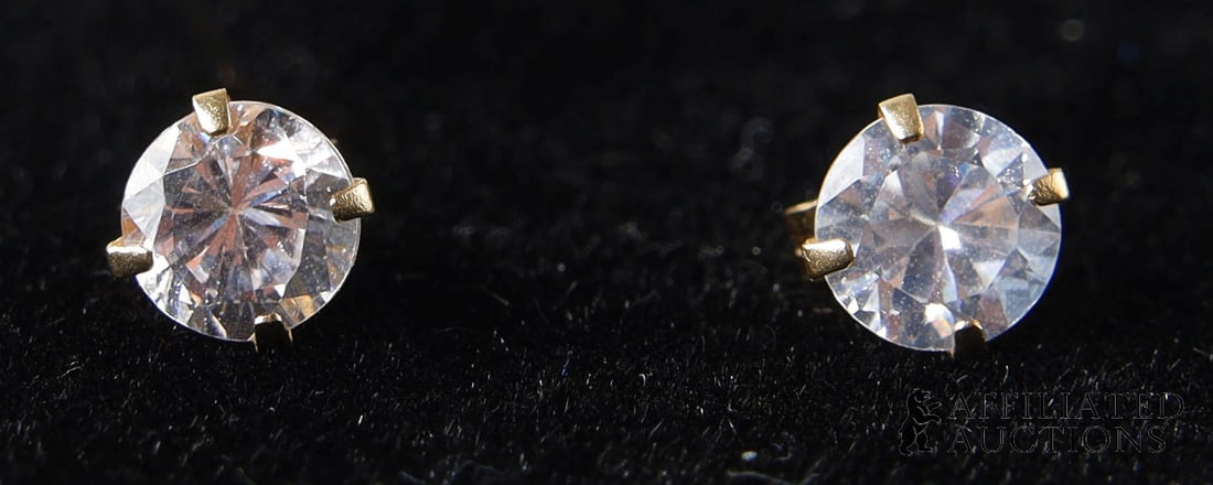 Solitaire Diamond Earrings 14K Gold April Gemstone: A pair of earrings featuring round solitaire diamonds, claw-set in marked 14K gold; diamond is an April birthstone. Each diamond measures 6.17 x 3.8 mm, and has a weight in the range of 0.85 to 0.91