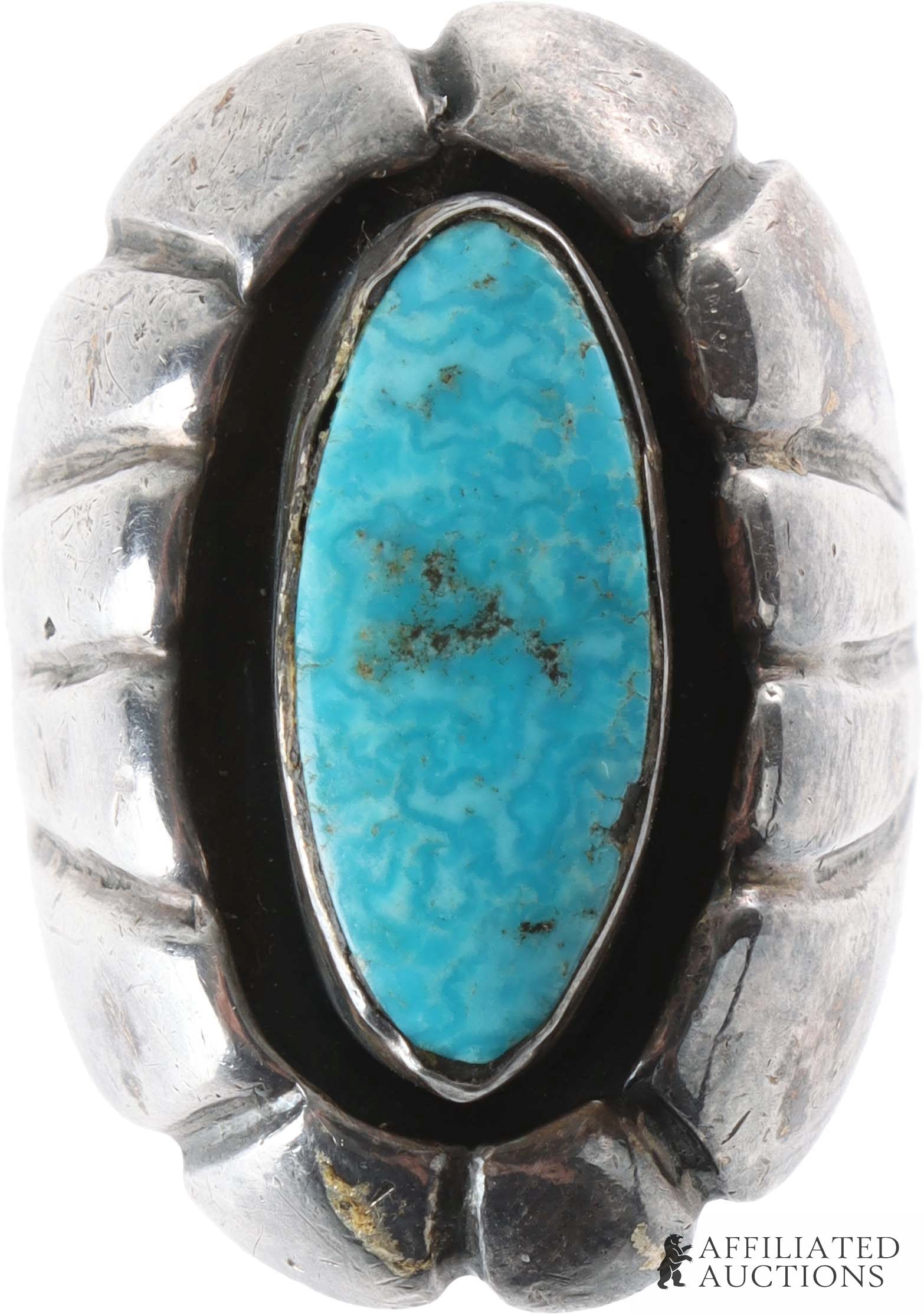 Southwest Native American Navajo Turquoise Ring: A .925 silver and turquoise ring in the style of the Navajo. Size 5. Weighs 13 grams. | This lot has a reserve.