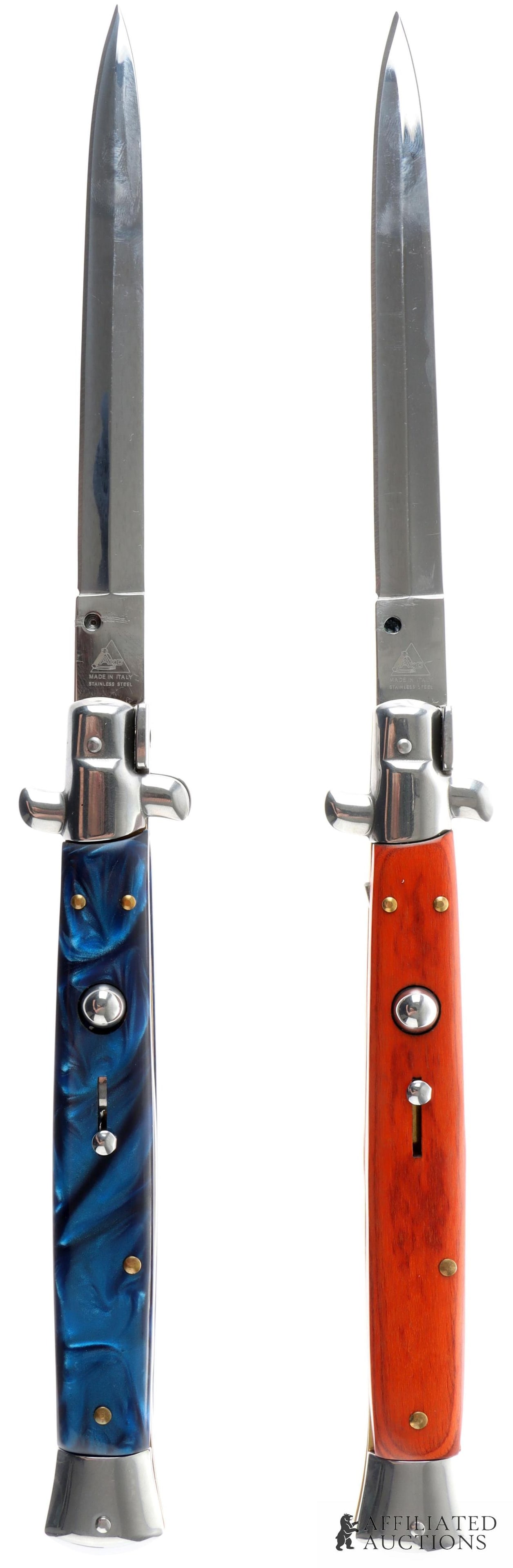 2 AKC 13 Inch Italian Switchblade Knife Lot: Lot of two AKC Italian-made switchblades. Knives measure 13 inches open, 7 inches closed. Blades are of stainless steel construction. One grip is of stained wood construction, one of blue opalescent p
